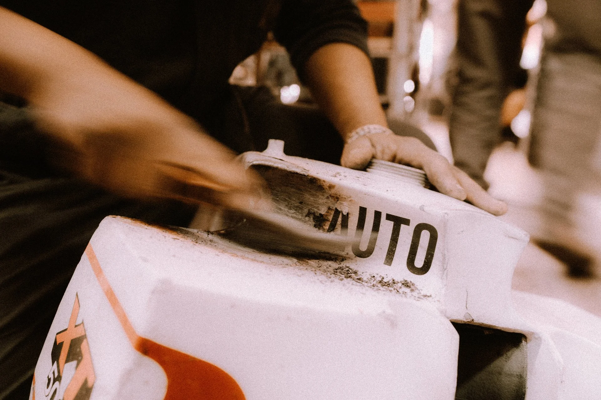 Person cleaning welding damage from a vintage Dakar XT 500 Sonata replica fuel tank. Shot from the film 100 Kicks in the Desert. Shot from the Brake Magazine film 100 Kicks in the Desert. © Richard Kurowski