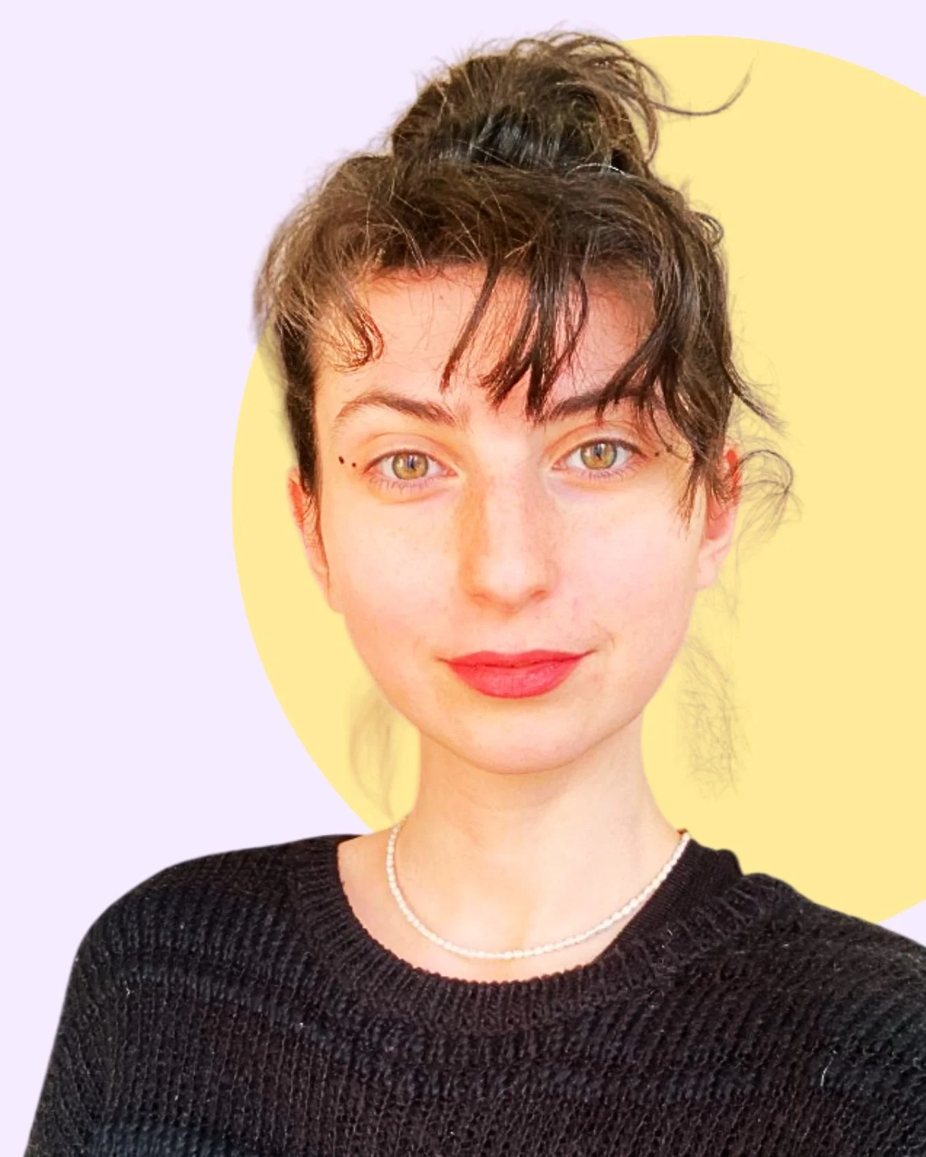A young woman with short, dark, curly hair tied in a messy bun, green eyes, light skin, wearing a black sweater, a pearl necklace, and lipstick, with a background featuring a yellow circle and pastel purple backdrop.