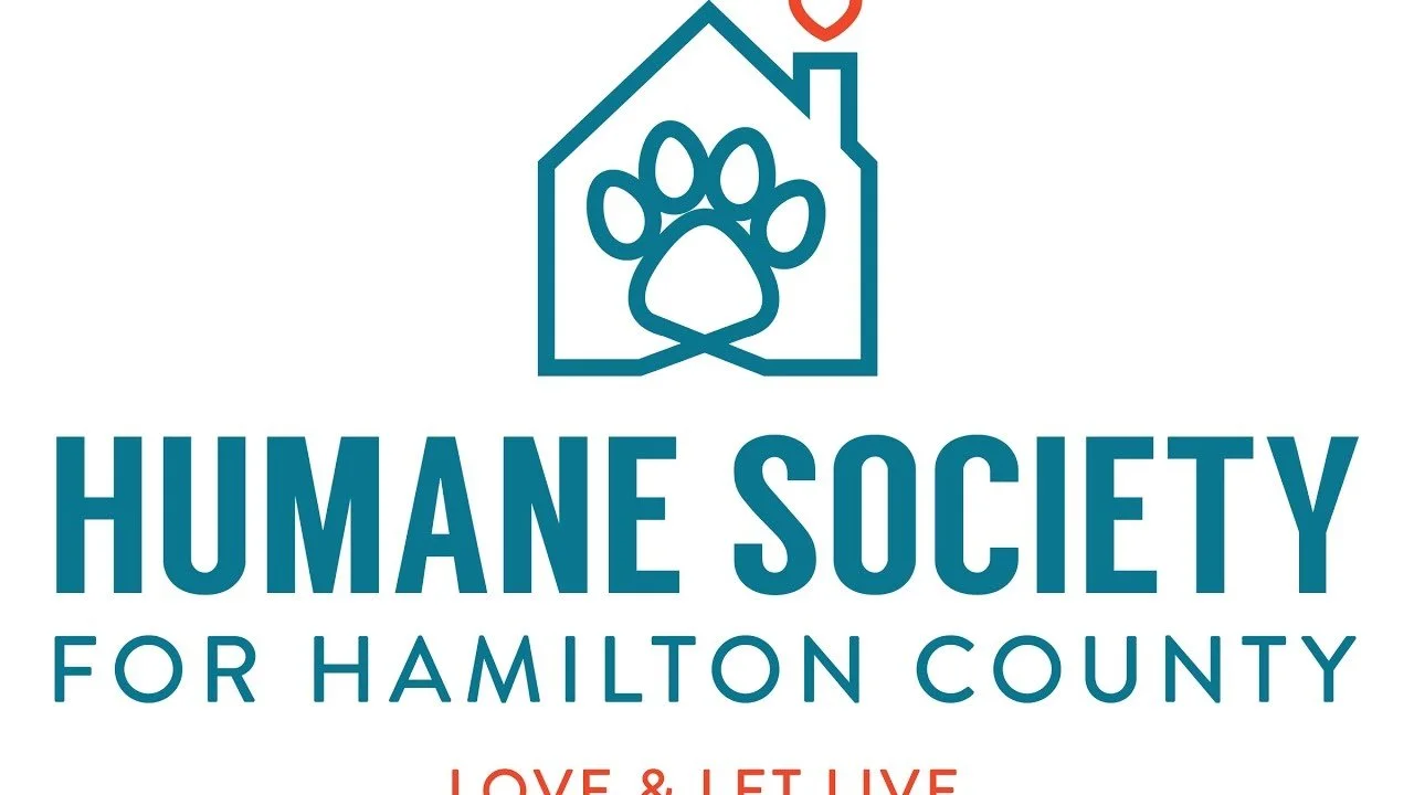Logo of Humane Society for Hamilton County featuring a house outline with a paw print inside and a small heart above the house, with the text "HUMANE SOCIETY FOR HAMILTON COUNTY LOVE & LET LIVE".