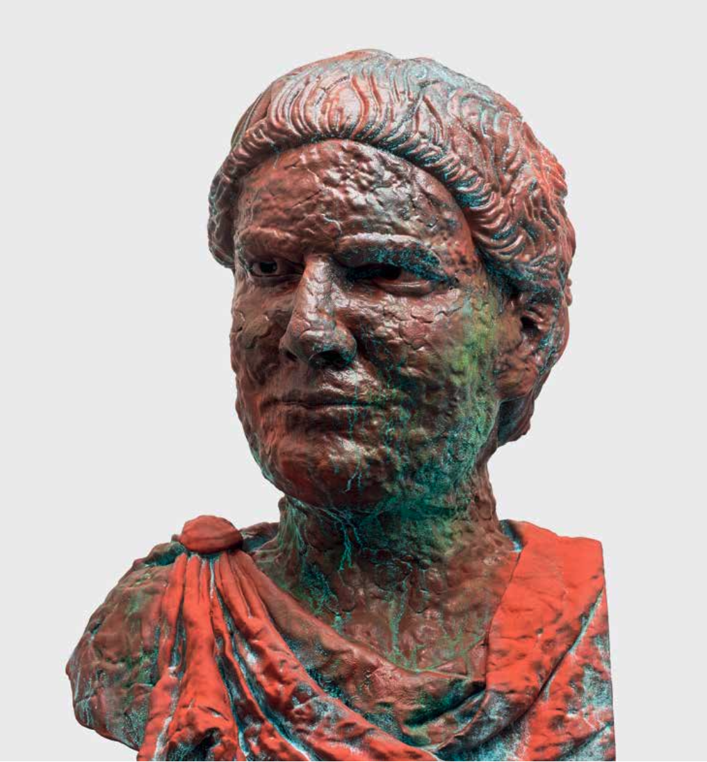 Bronze bust sculpture of a woman with a serious expression, wearing a draped garment.
