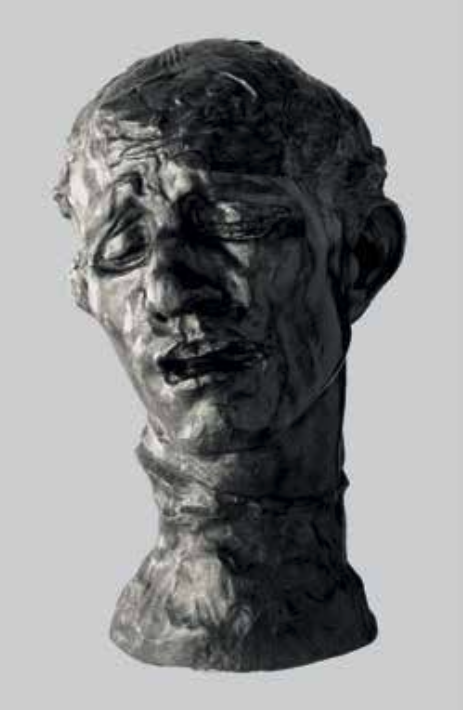 Sculpture of a distressed young man's bust with a somber expression and closed eyes.
