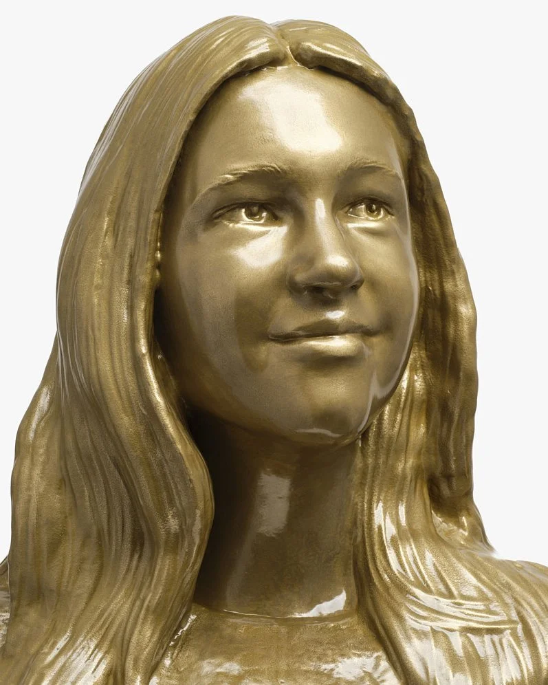 Bronze sculpture of a woman's head and shoulders with long wavy hair, looking slightly upward.