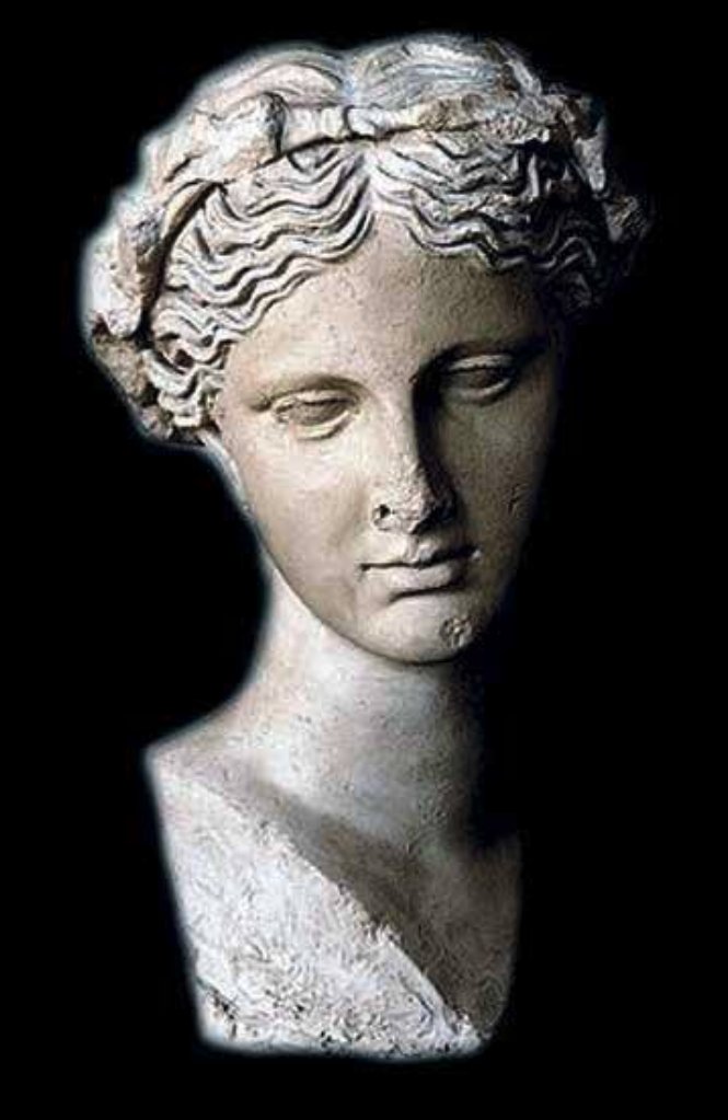 A marble bust of a woman with wavy hair, set against a black background.