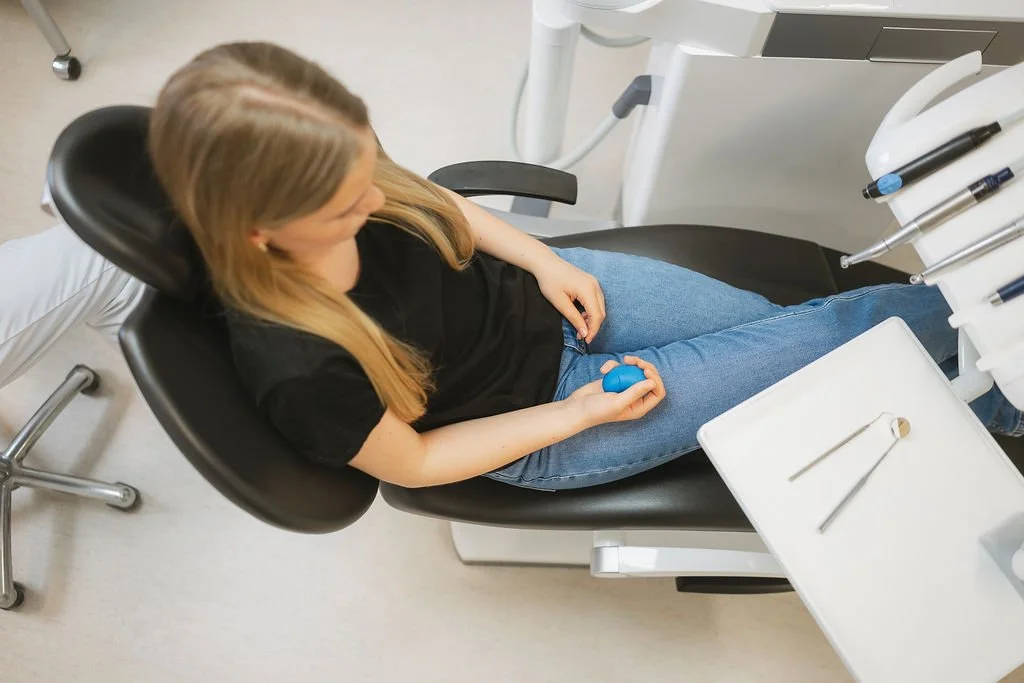 Patient using coping support during dental appointment
