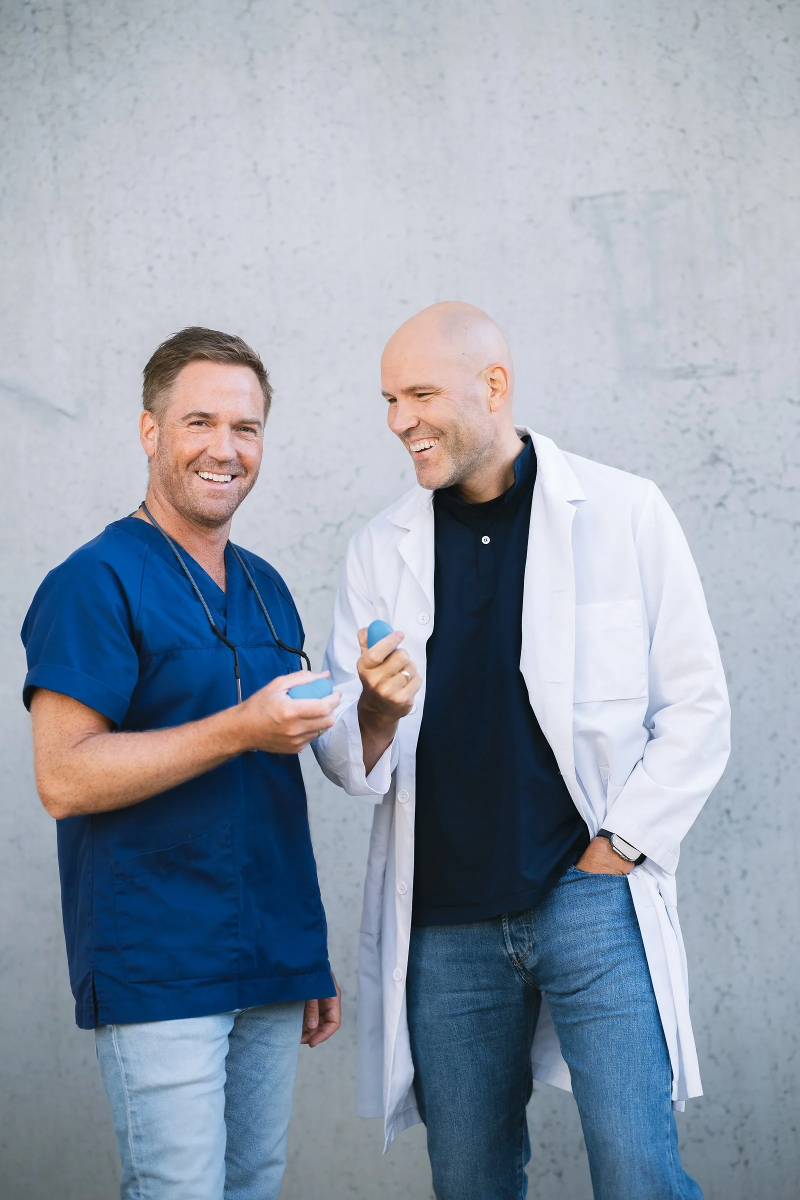 Grasp founders, a dentist and physician, holding the coping device