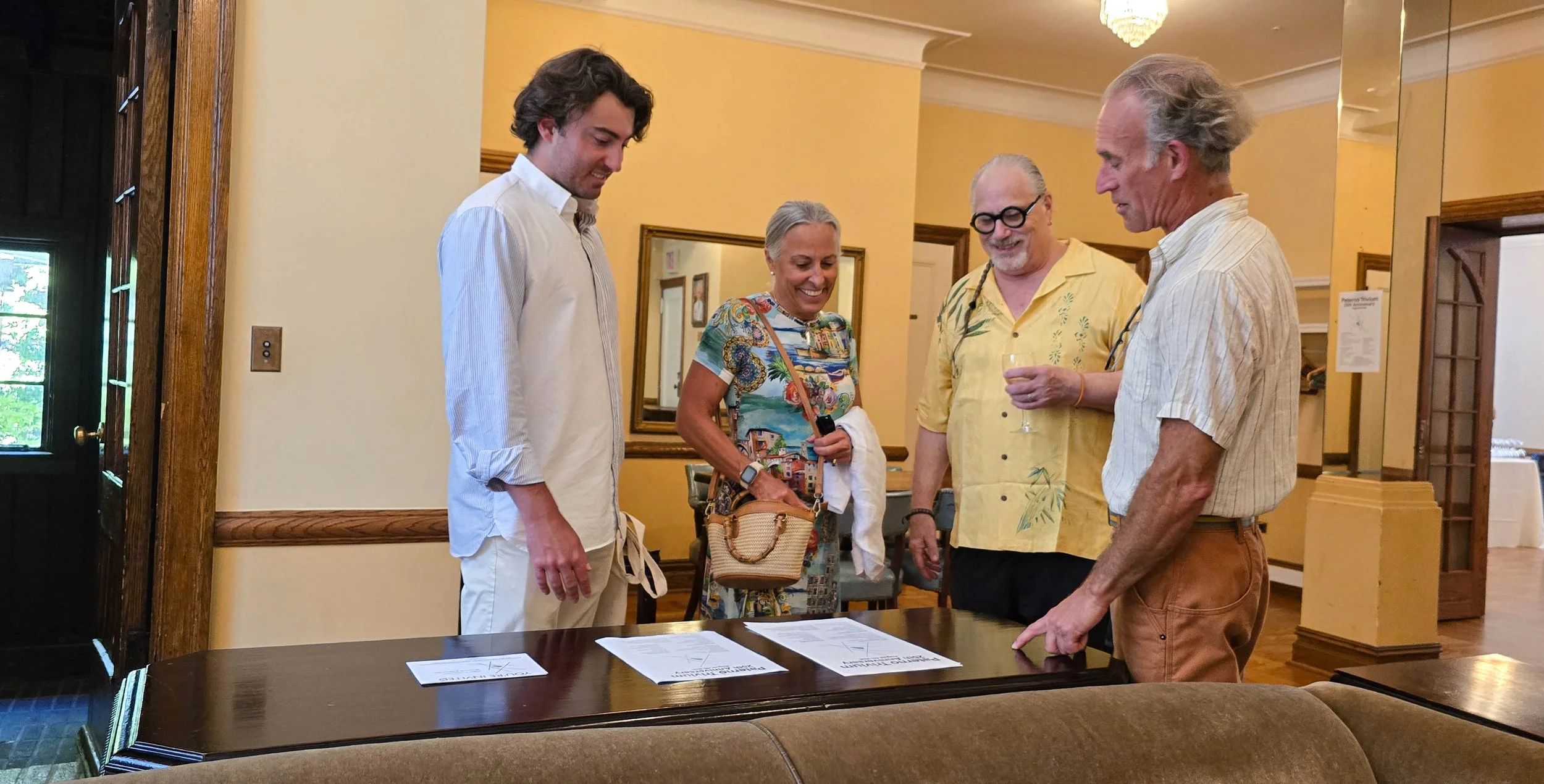 Paterno family being shown the 25th Anniversary Event Flyers by Frank Juliano (l) and Craig Peden (r) Event Organizers                                                                                                                                    