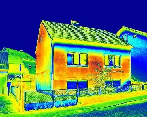 Infrared thermal image of a house showing temperature differences in colors from blue to red.