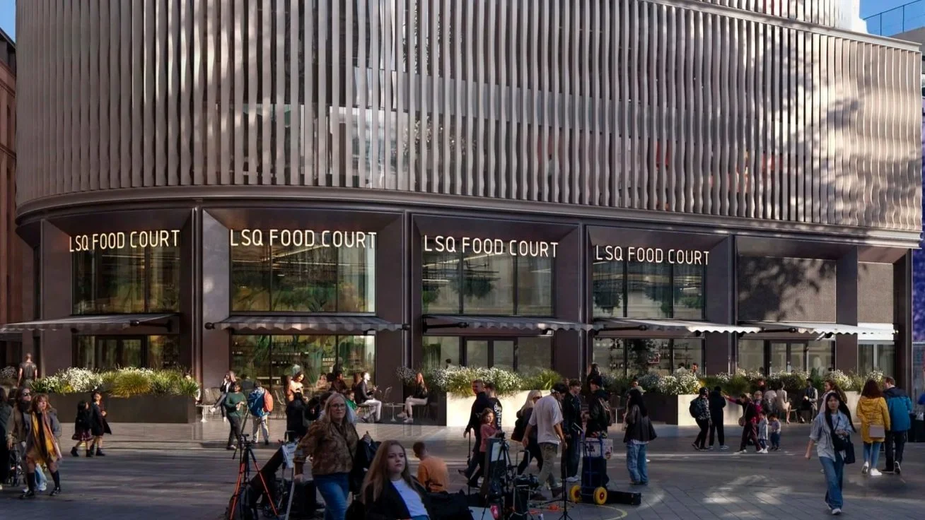 Proposed LSX Development. Exterior of a modern building labeled LSX Food Court with large glass windows and a crowd of people walking and sitting outside.