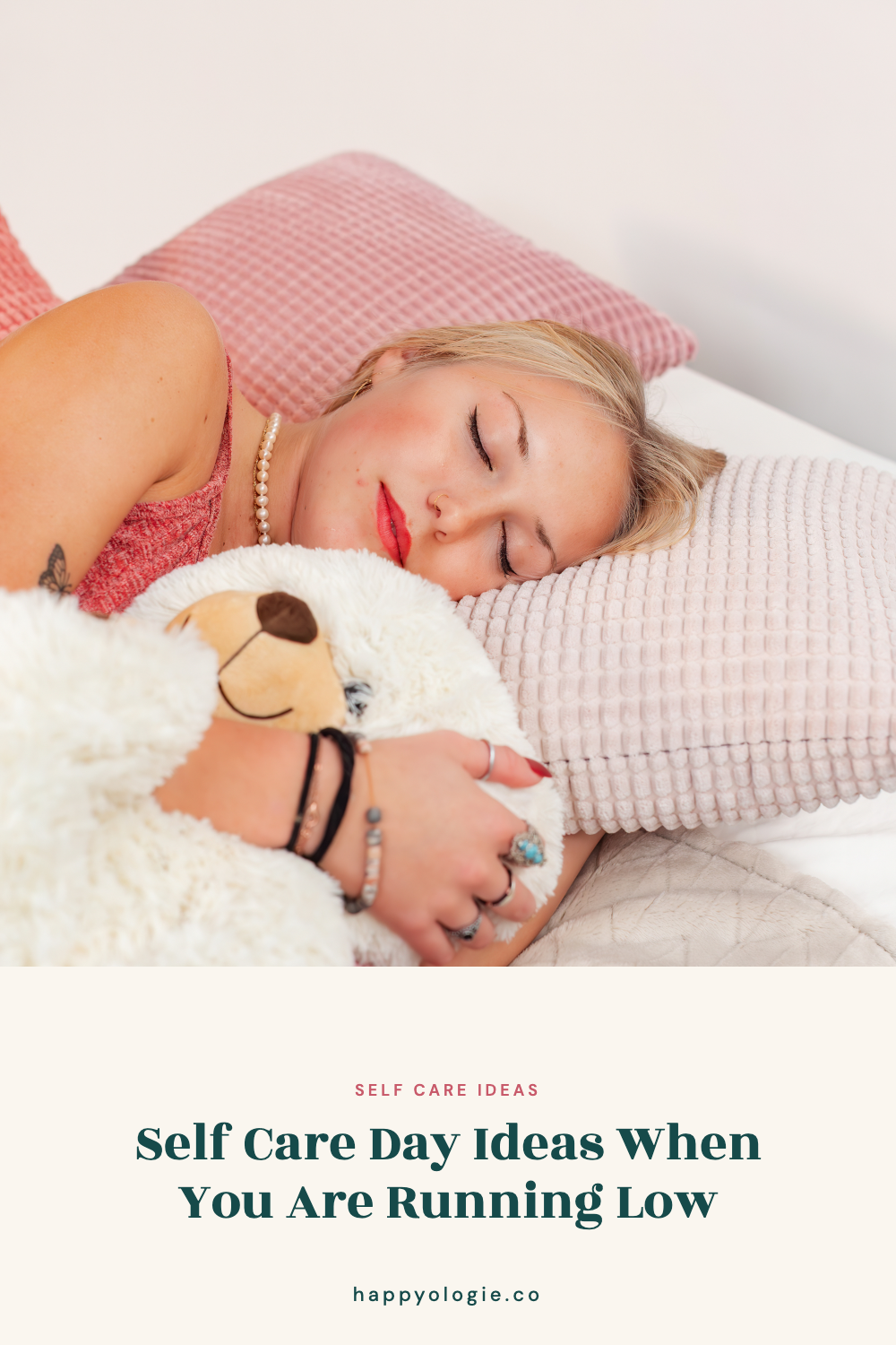 College student resting in bed while holding a soft teddy bear.