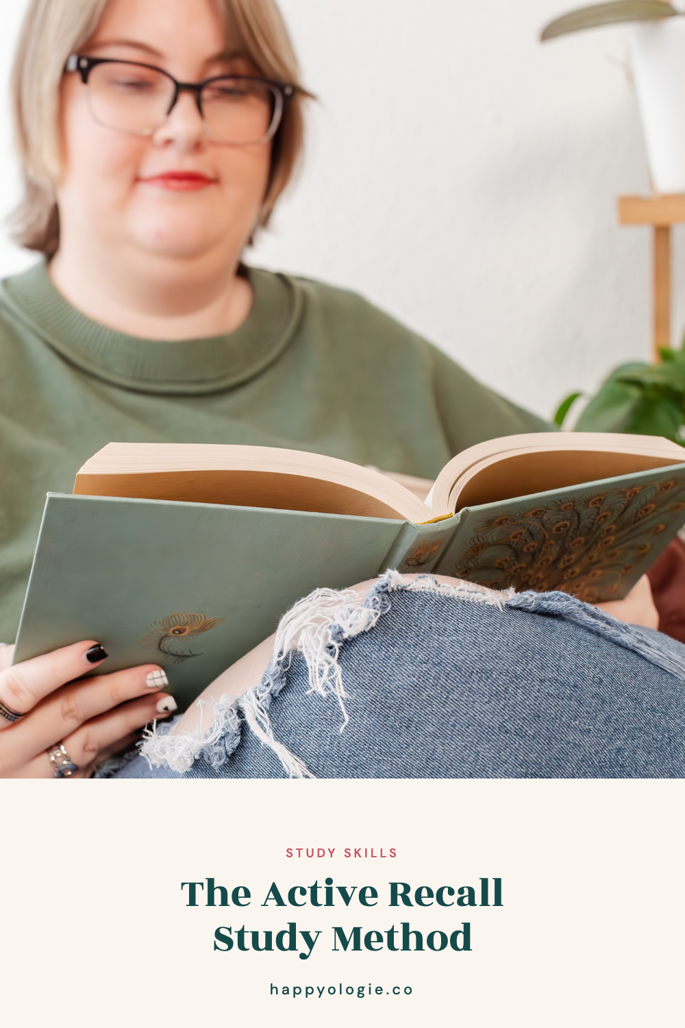 College student reading an open book while sitting in a chair.