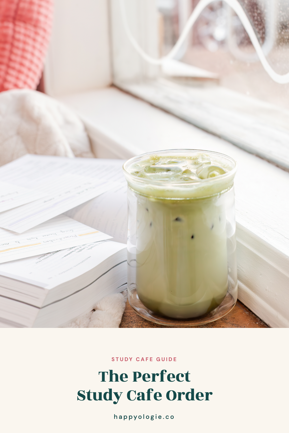 Iced matcha beside textbooks and study papers on a bright cafe-style windowsill.