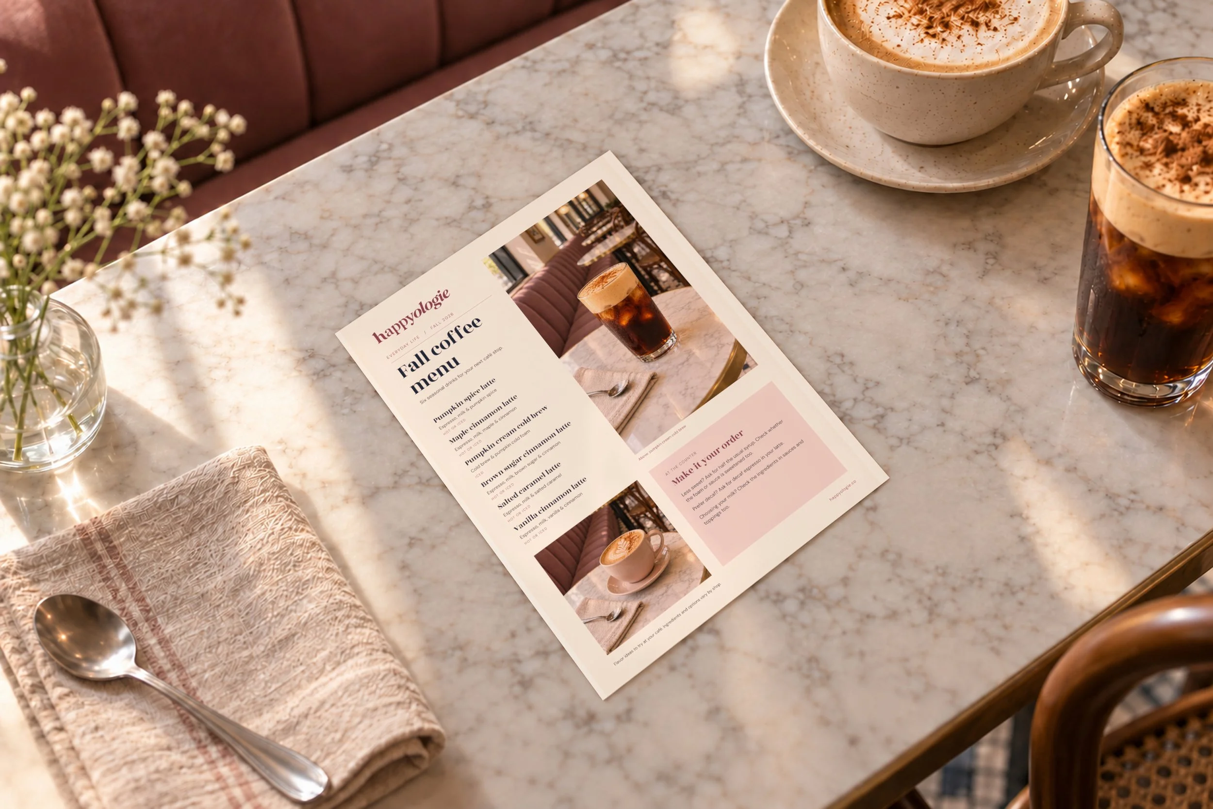 Wide view of the Fall Coffee Menu with coffee, flowers and a linen napkin at a café.