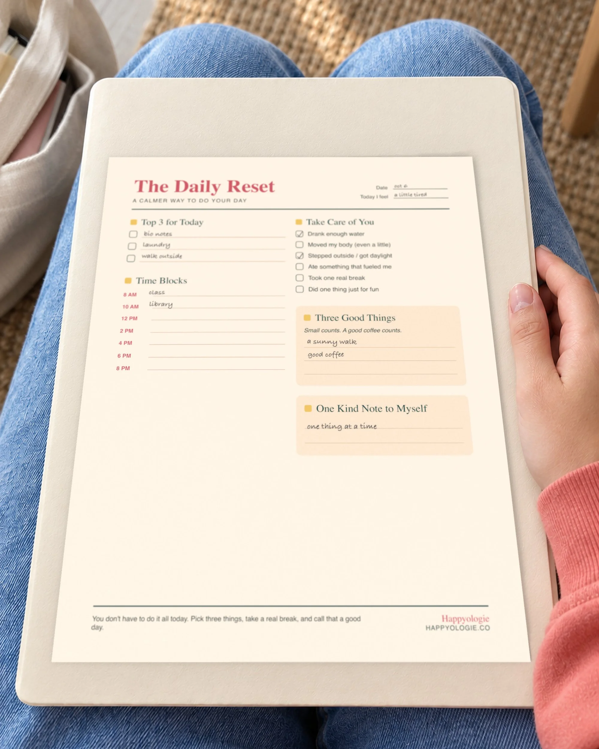 The Daily Reset planner resting on a folder between classes.