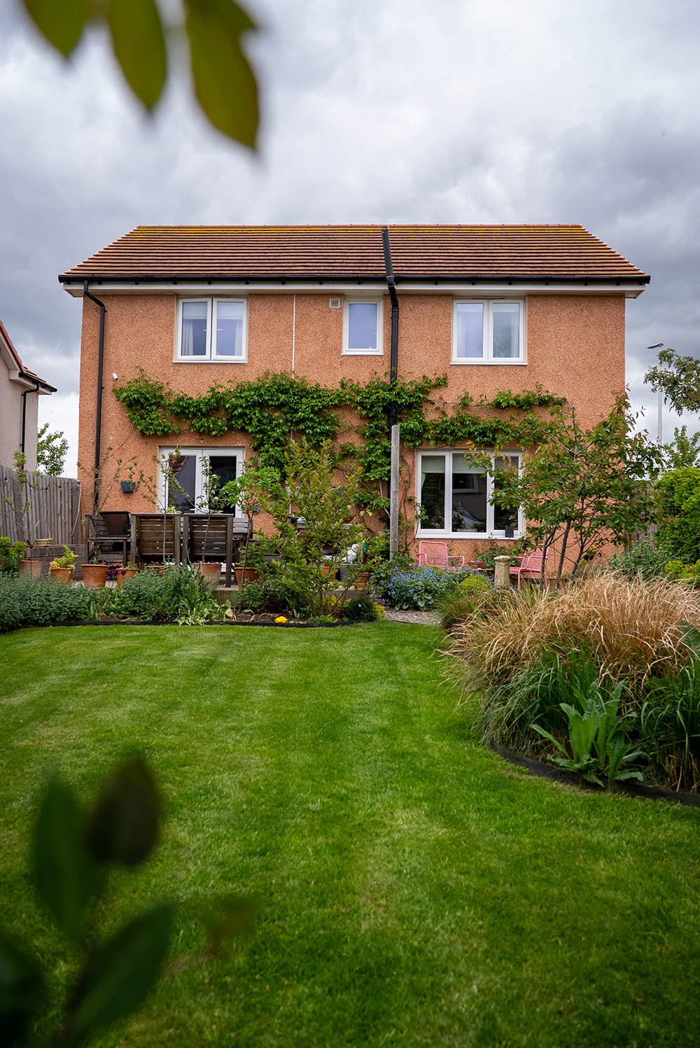Photo of a new build house with a established landscaped garden created by Dune Landscape Gardens.