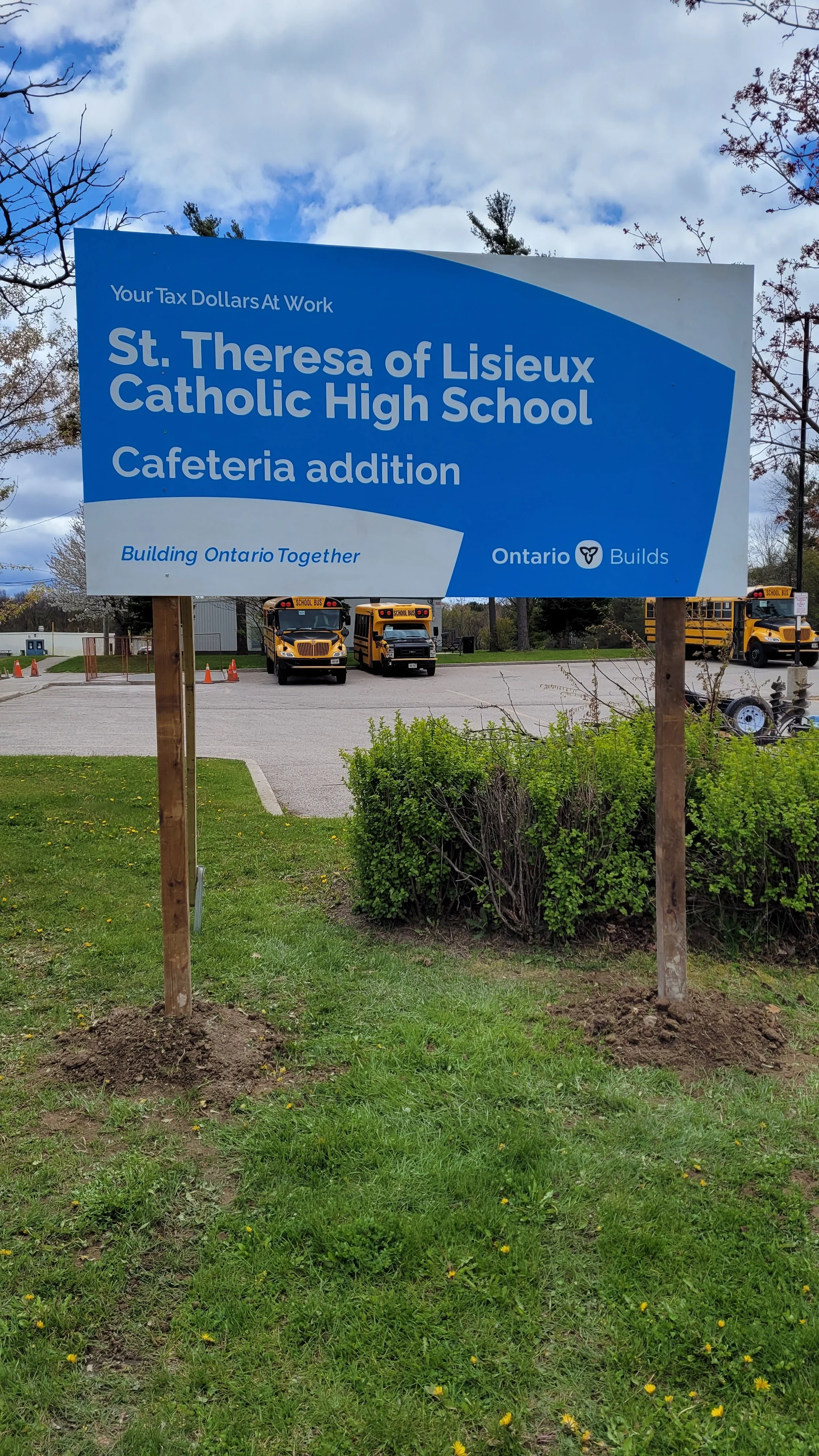 Sign indicating efforts to build Ontario together, sponsored by Ontario Builds, for St. Theresa of Lisieux Catholic High School cafeteria addition.
