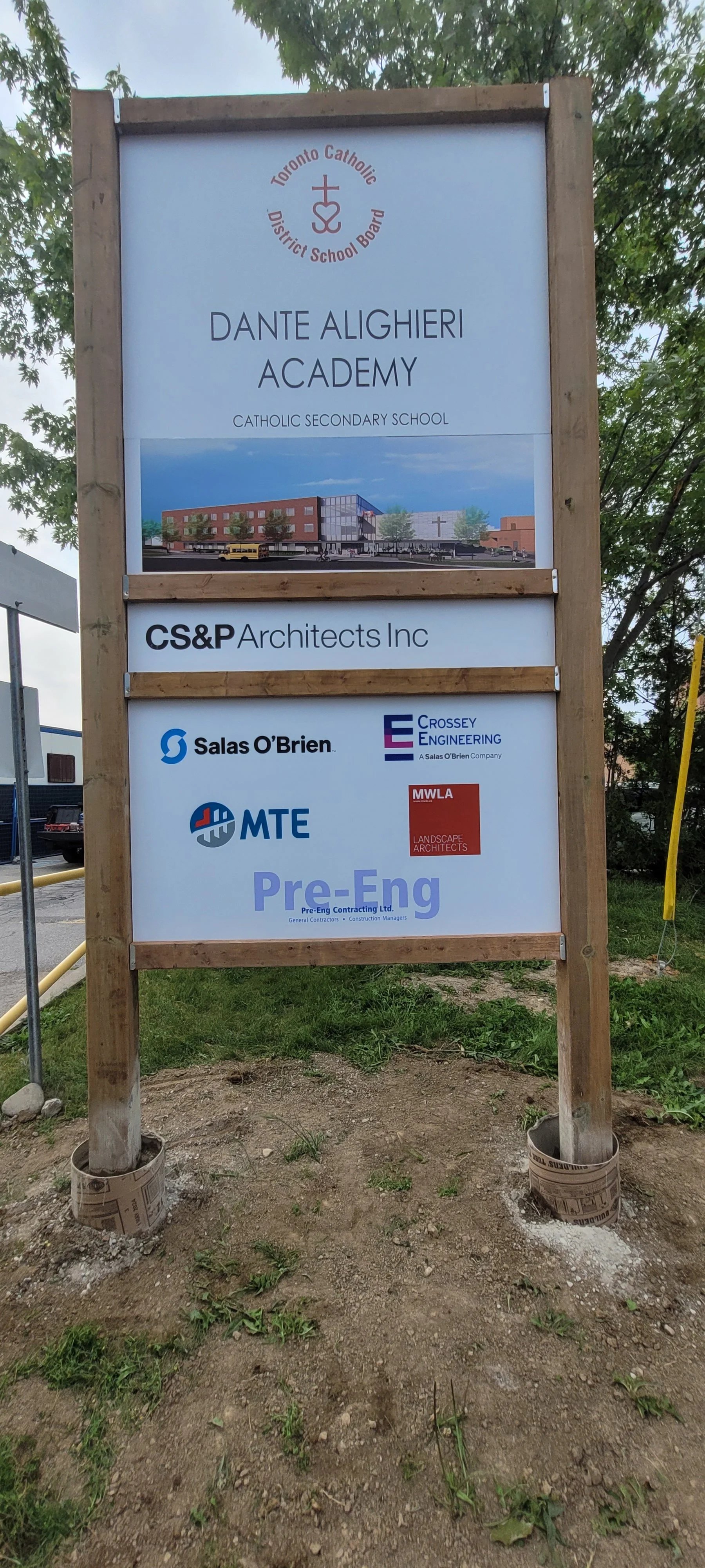 Signboard for Dante Alighieri Academy, a Catholic secondary school in Toronto, with logos of architectural and engineering firms involved in its construction.