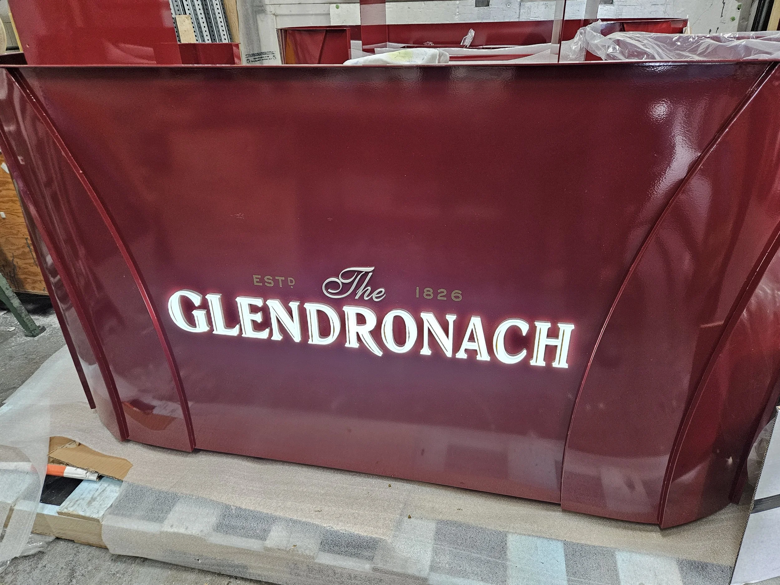 A red vintage-style display sign with the text 'The Glendonach 1826 ESTD' in white illuminated letters.