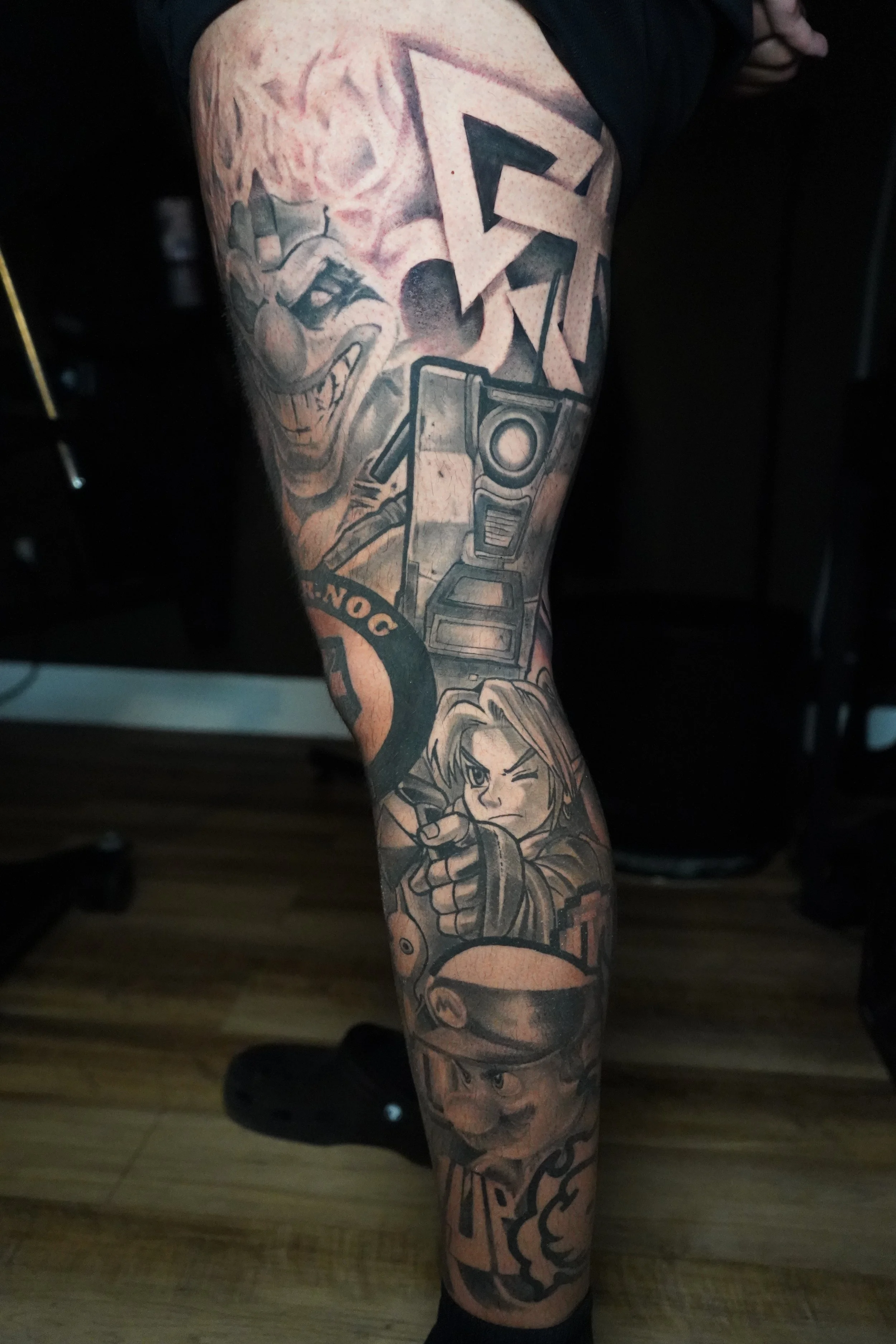 Tattoo sleeve featuring character illustrations from the Super Smash Bros. video game series, including Dr. Mario and Link.