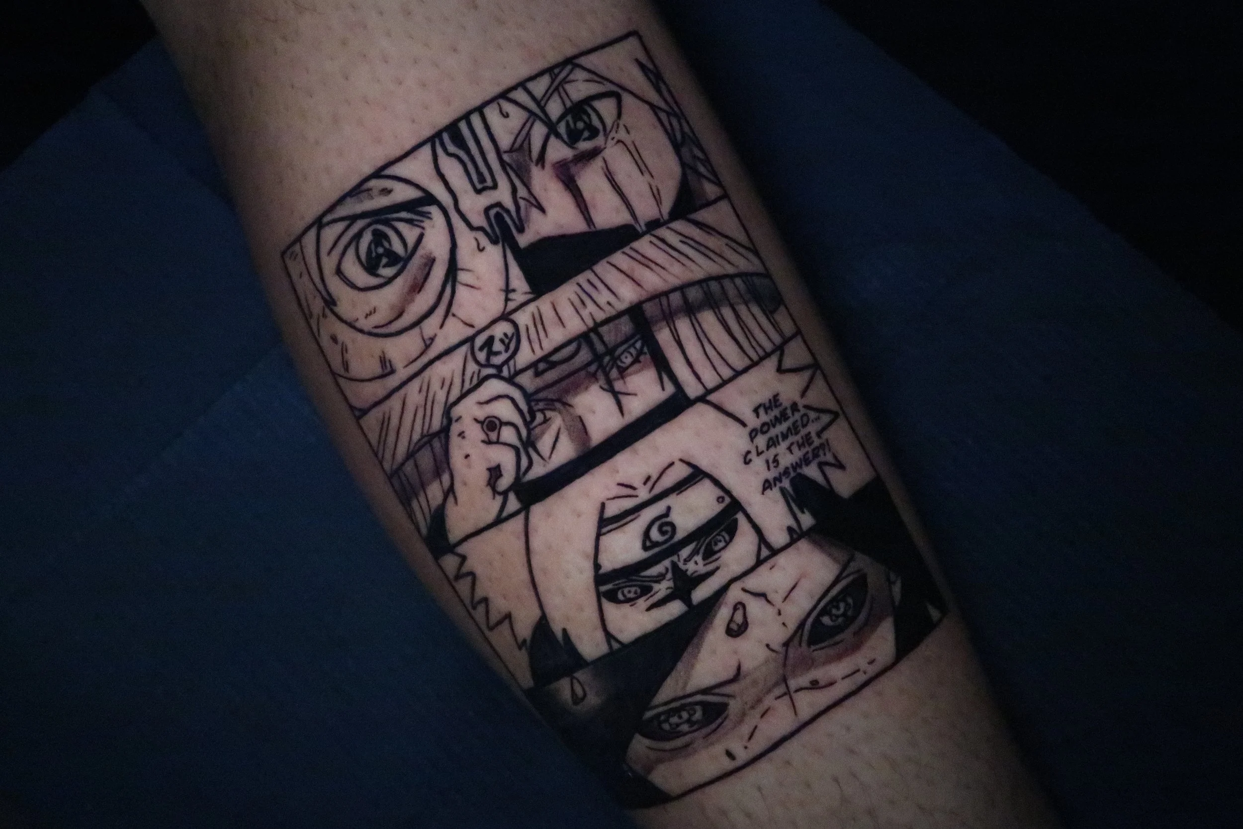Tattoo of a black-and-white comic strip featuring multiple panels with faces and hand gestures, including Naruto Uzumaki, with text saying "The power claimed is the answer."