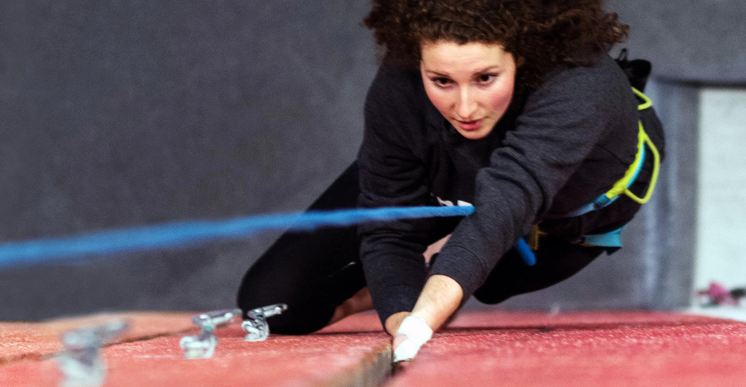 Rock climber learning crack climbing at Planet Rock