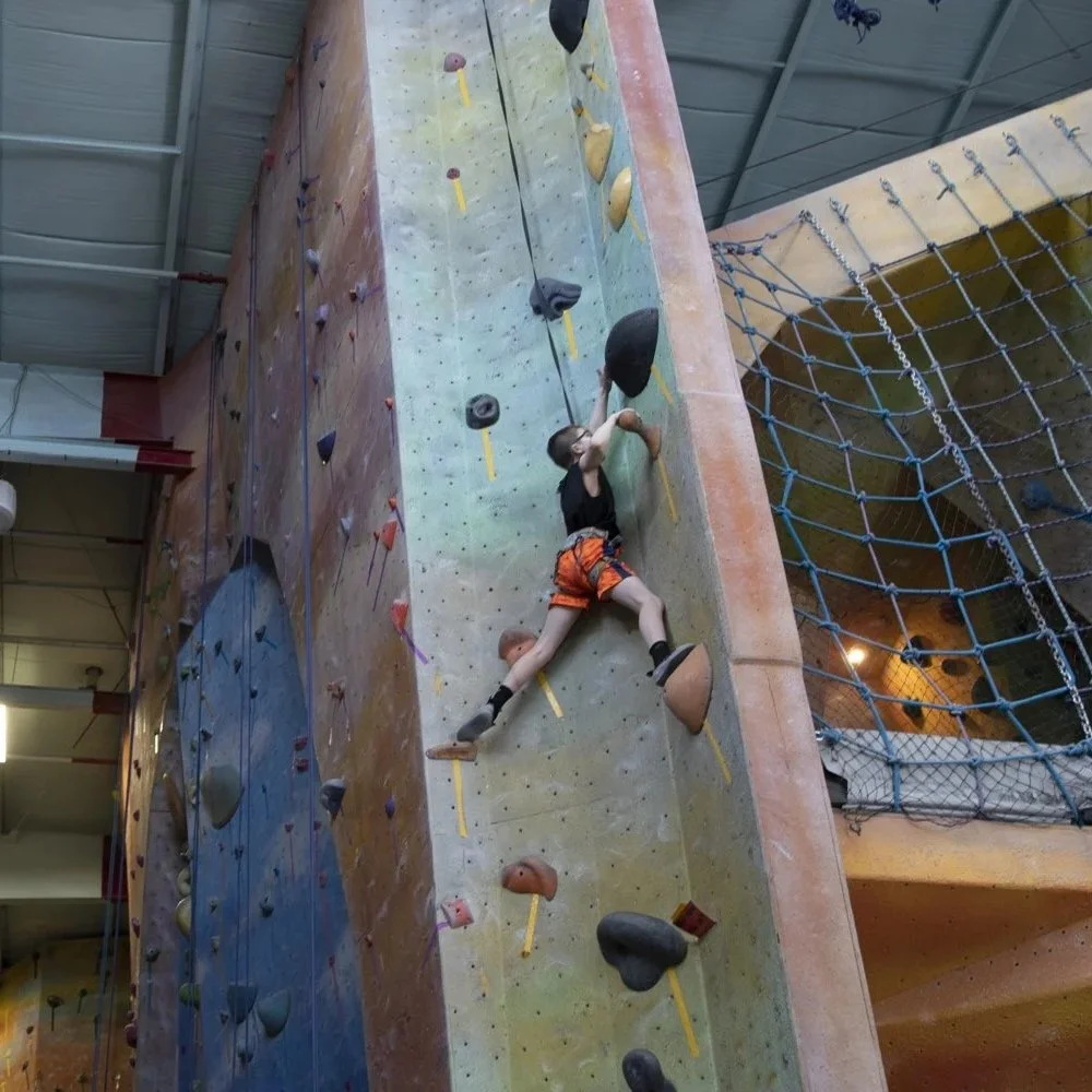 Climber on auto belay system at Planet Rock