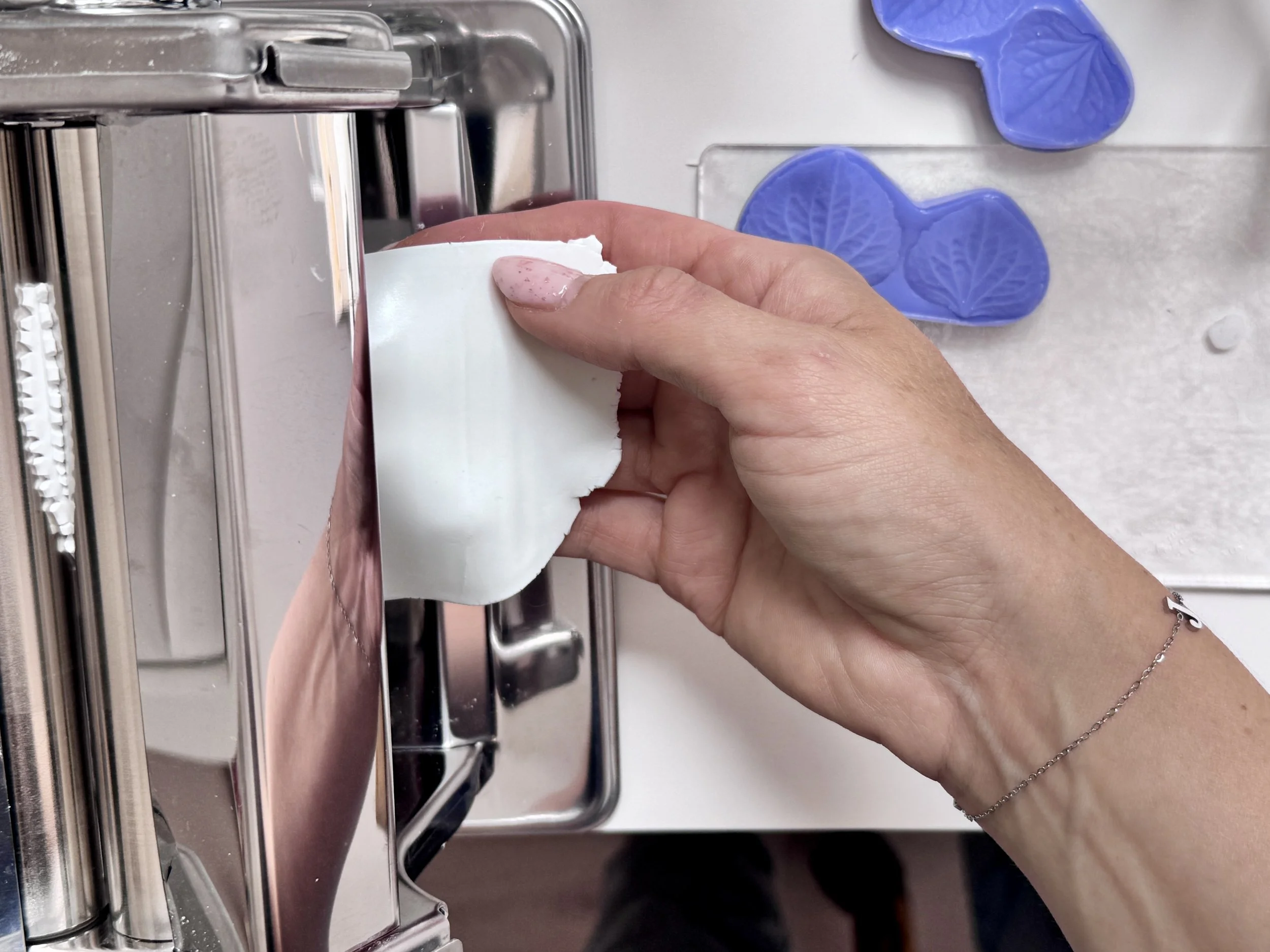 Step-by-step process of creating handcrafted clay flower petals for bespoke bridal hair accessories.