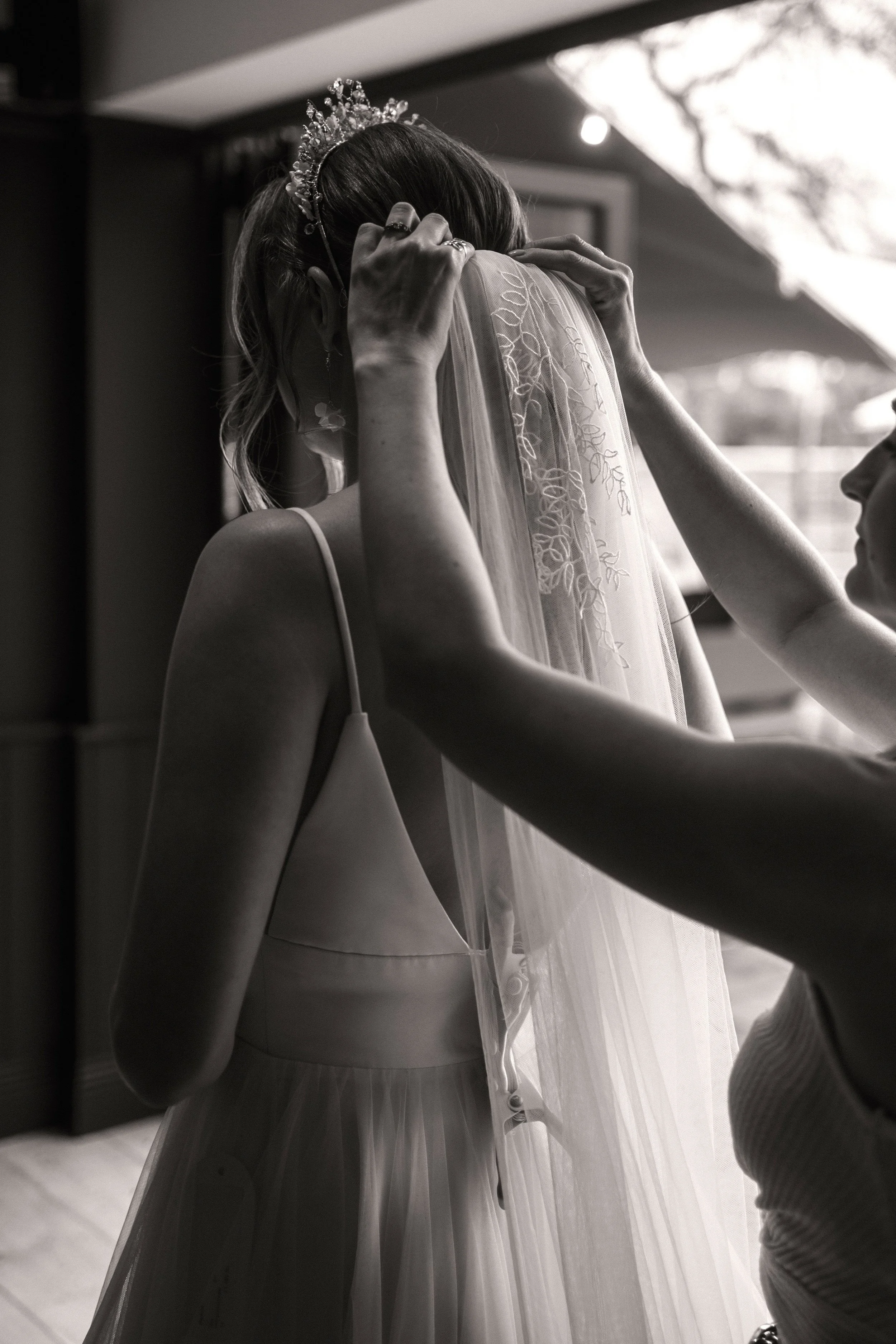 Bride wearing a designer bridal crown and tiara, showcasing a couture bridal accessory styled during wedding morning preparations.