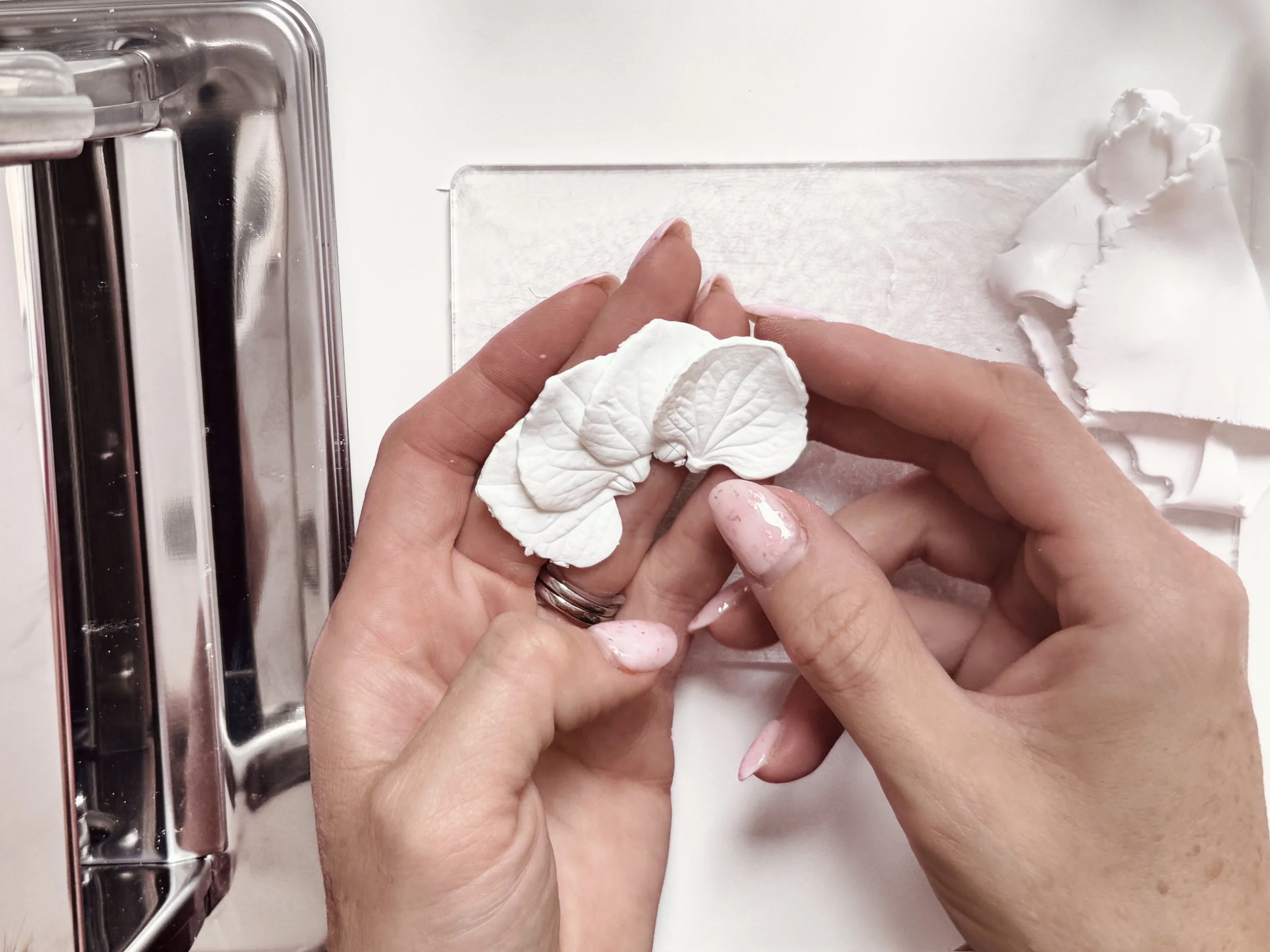 Close-up of bespoke bridal headpiece design in progress, featuring gold wire, pearls and handcrafted floral details.