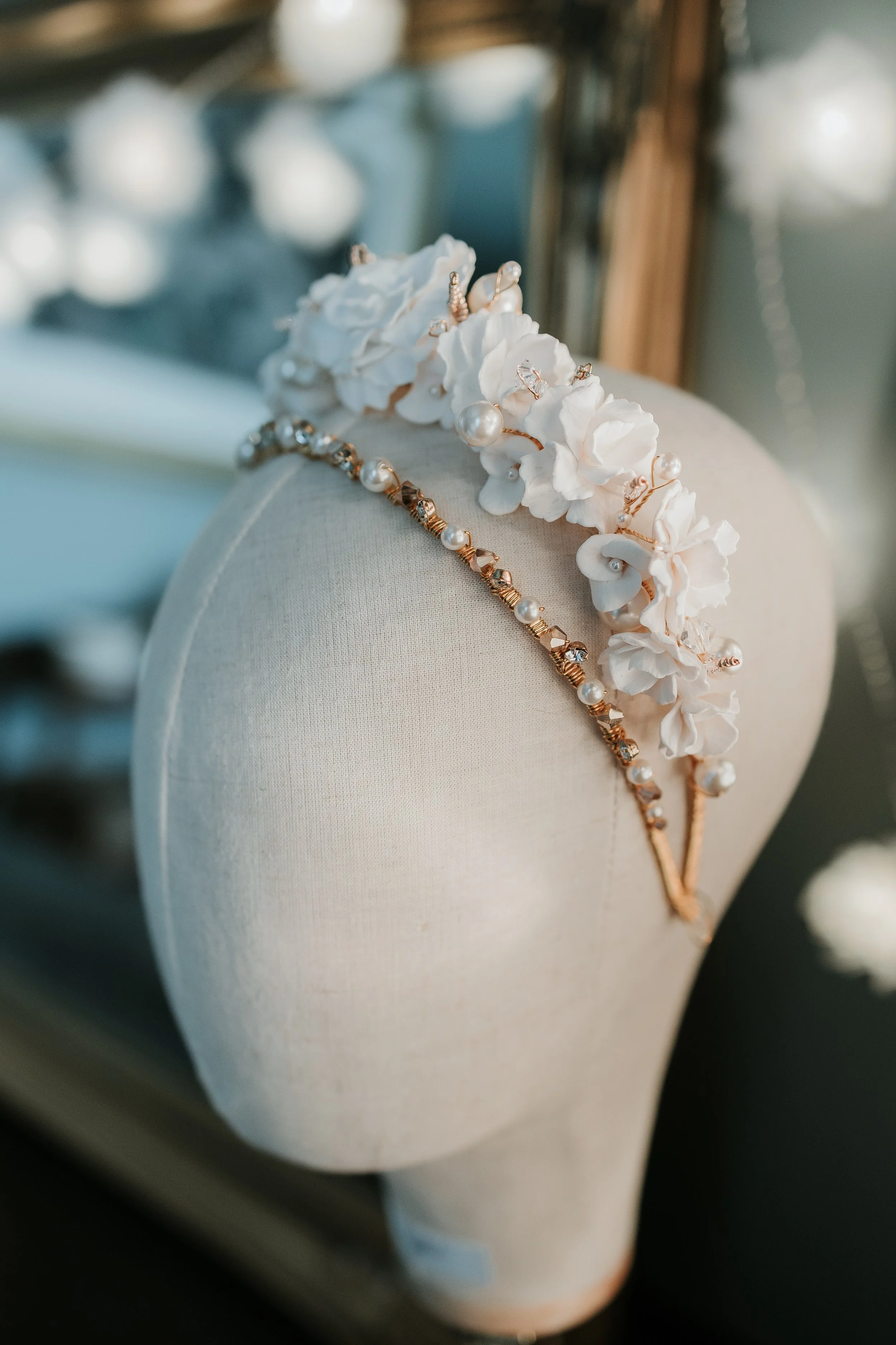 Handmade ivory floral bridal headband from Jen Gilbert Couture Bridal Accessories featuring soft fabric flowers, pearls, and rose gold wire, designed for elegant wedding hairstyles.