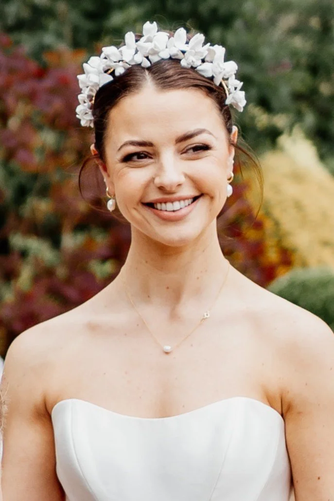 Bride wearing a petite floral bridal crown featuring handcrafted clay iris flowers, designer couture wedding crown.