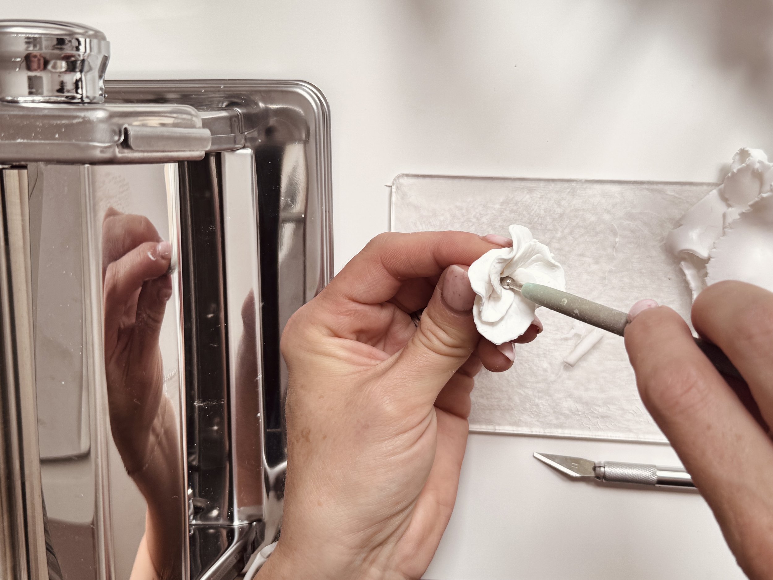 V-Step-by-step process of creating handcrafted clay flower petals for bespoke bridal hair accessories.