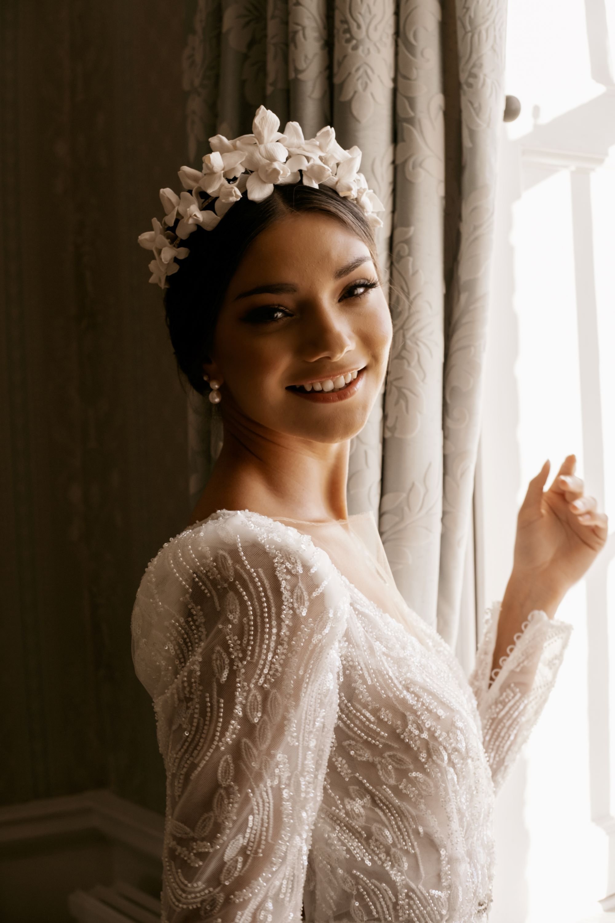 Bride wearing a handcrafted floral bridal crown by Jen Gilbert Bridal, featuring sculpted clay iris flowers designed as a modern couture wedding crown.