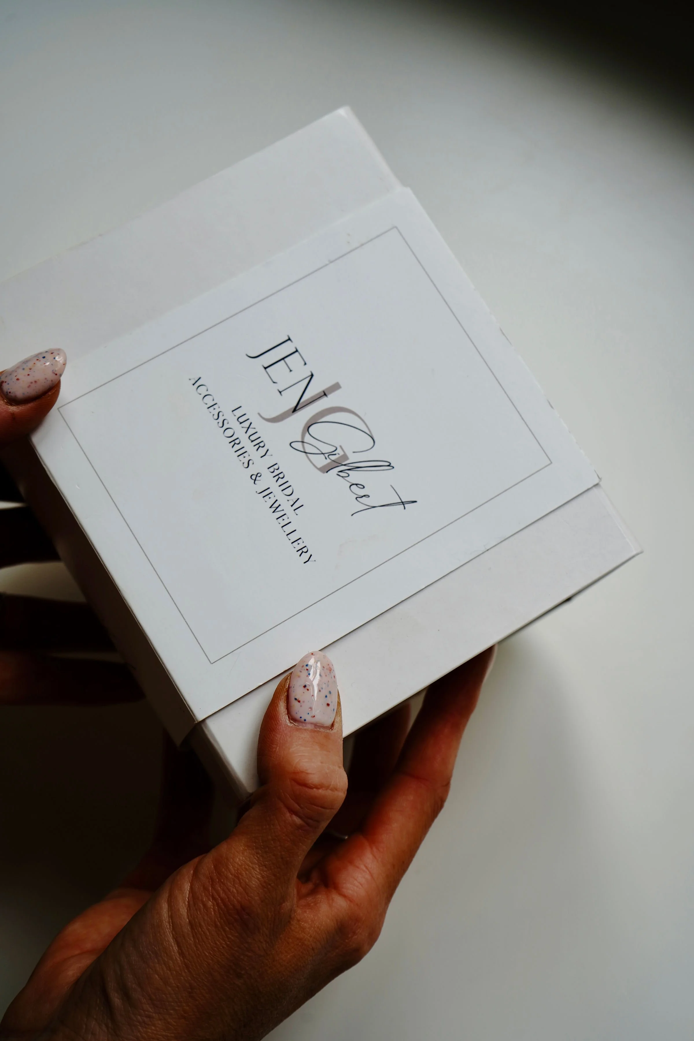 Jen Gilbert Bridal branded protective box used to package luxury handcrafted bridal accessories, presented in elegant, eco-conscious packaging.