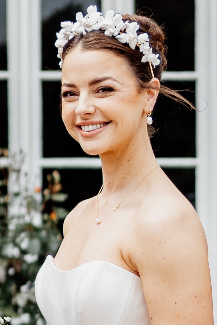 Bride wearing a petite floral bridal crown featuring handcrafted clay iris flowers, designer couture wedding crown.