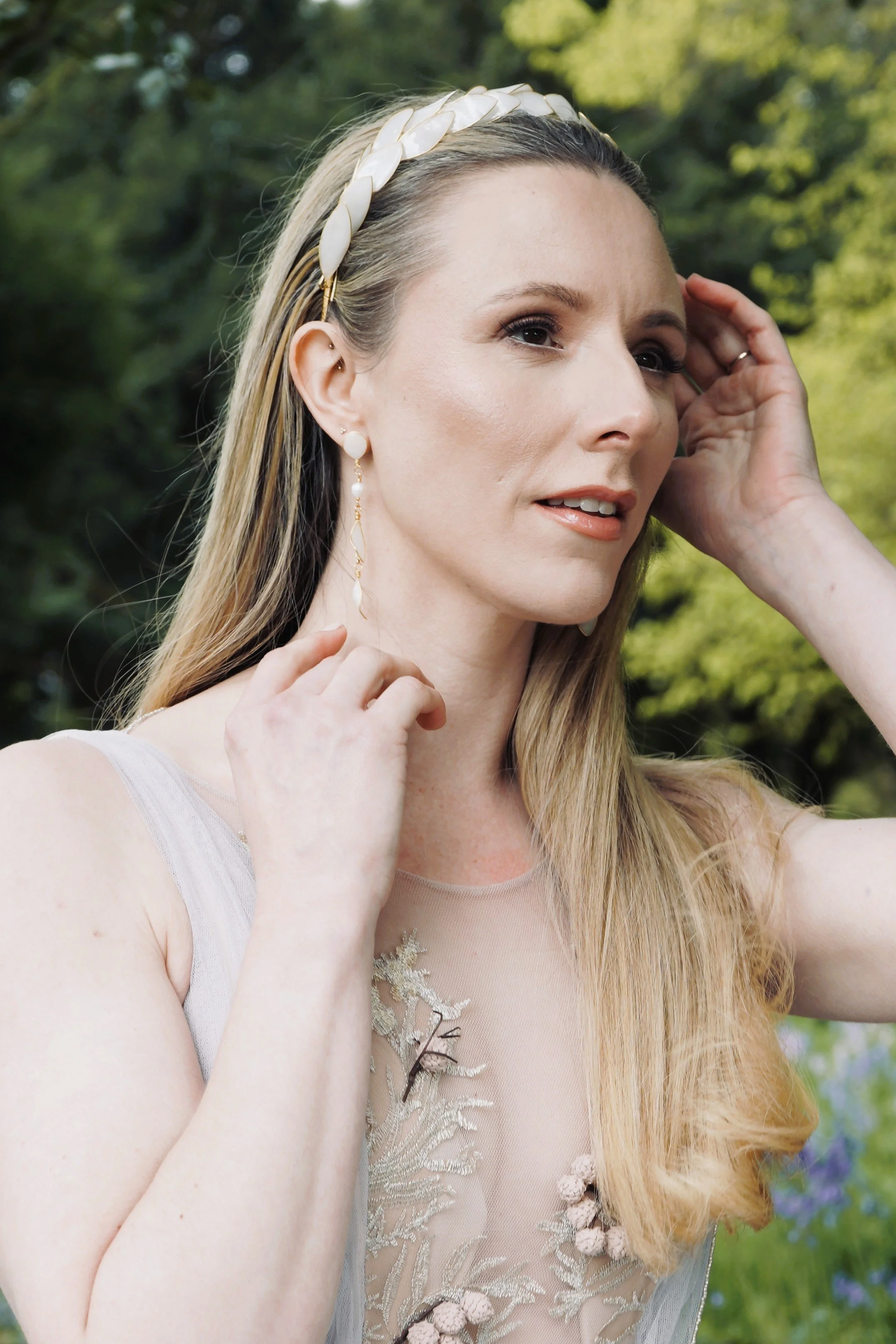 Elegant bride wearing a handcrafted bridal tiara and pearl earrings by Jen Gilbert