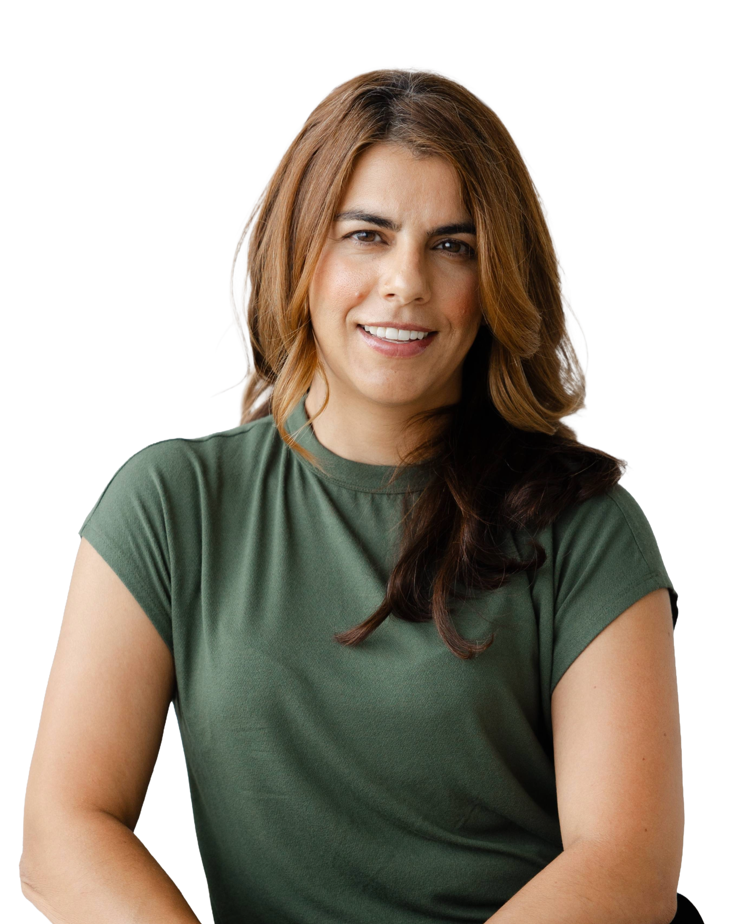 A woman with shoulder-length brown hair wearing a green t-shirt, smiling at the camera.