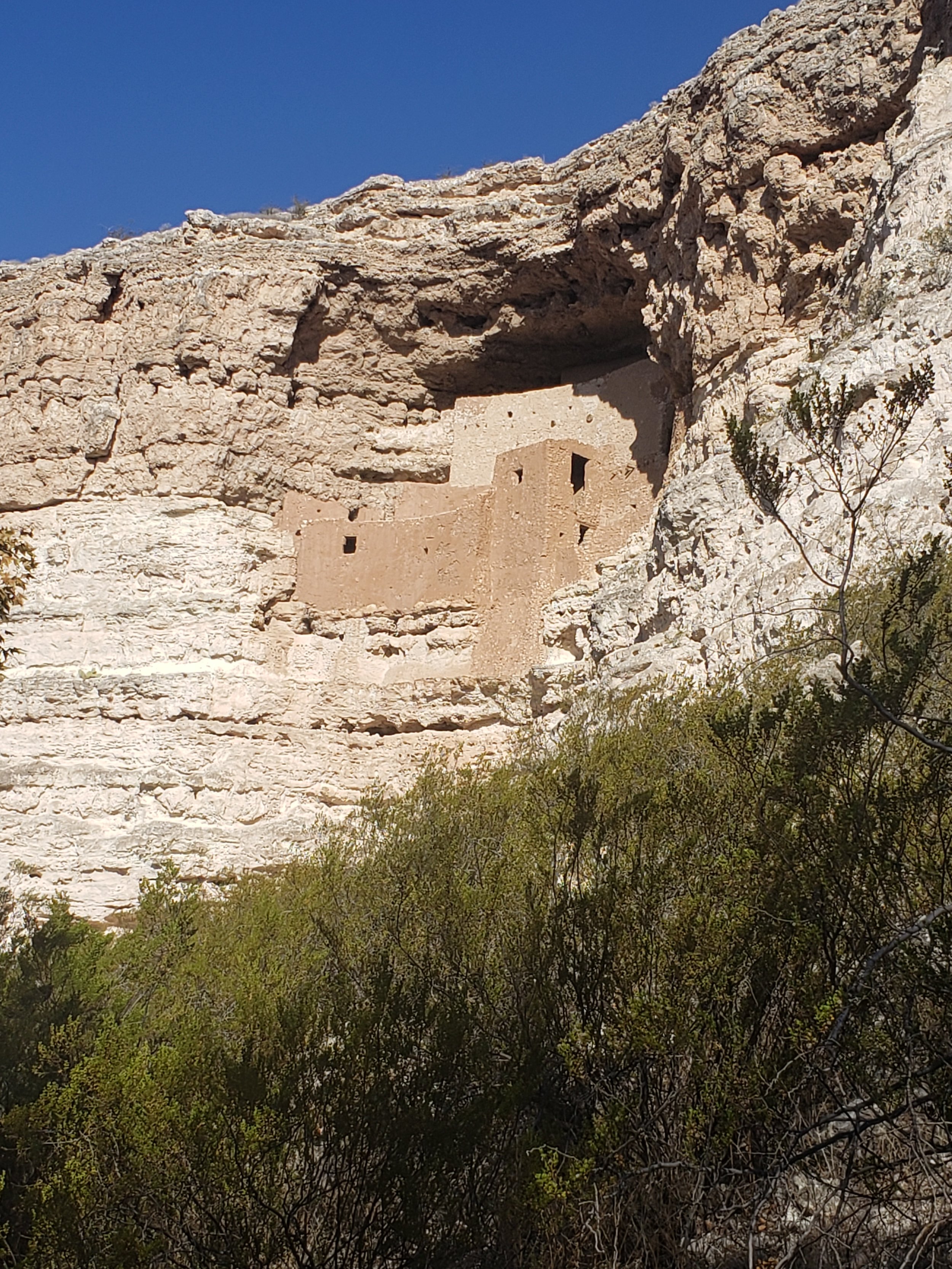 Cliffside ancient structure built into the rock face.