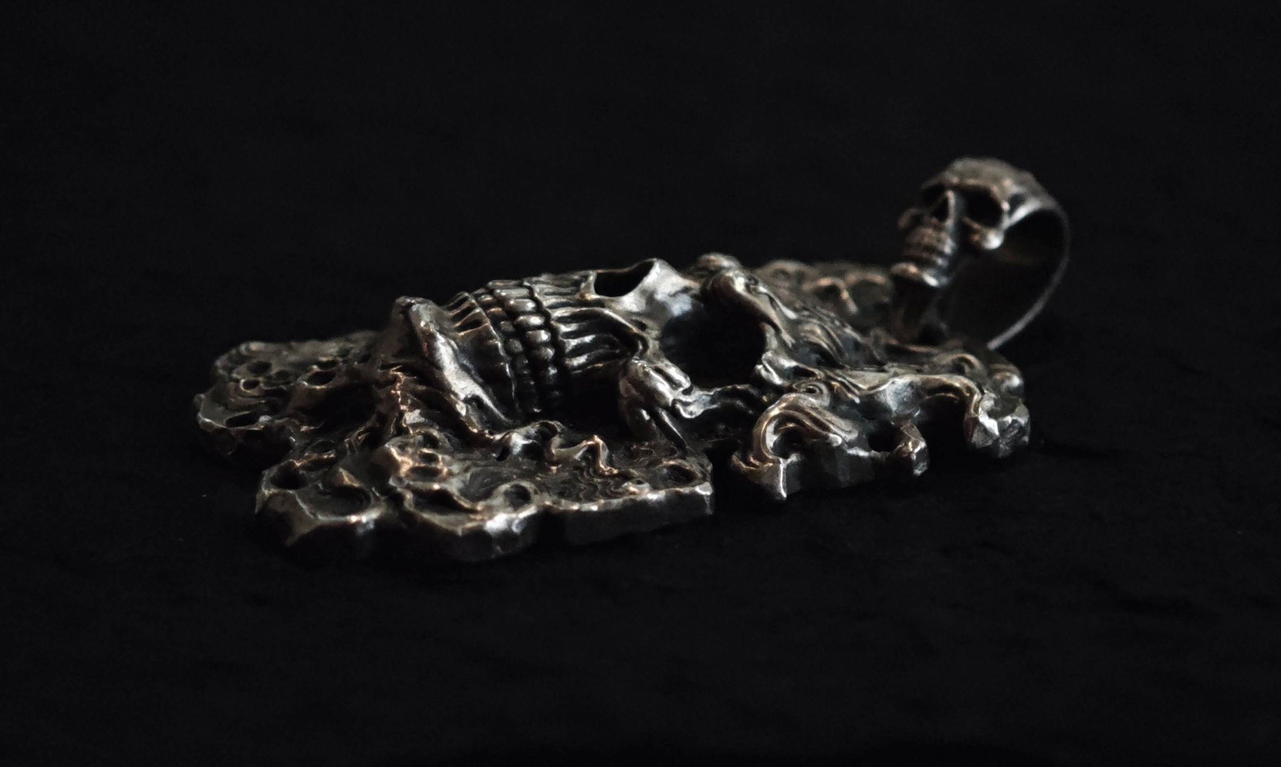 Xia Penghao FireYa Abyssal Reawakening Pendant - Side angle on tabletop showing texture and detail