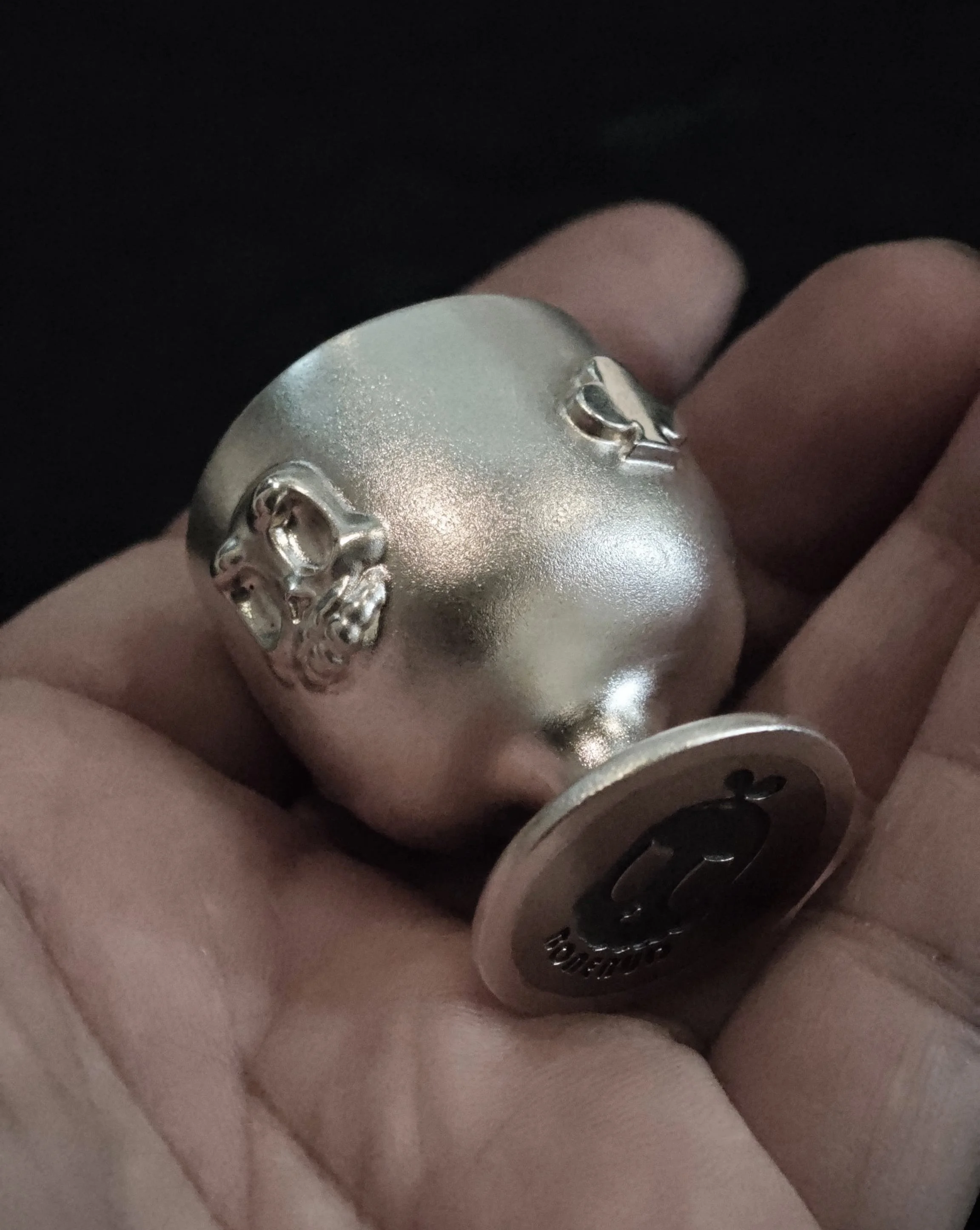Xia Penghao BONE BUD CLUB CUP - Lying on hand showing BONE BUD skull, club relief, and logo on base