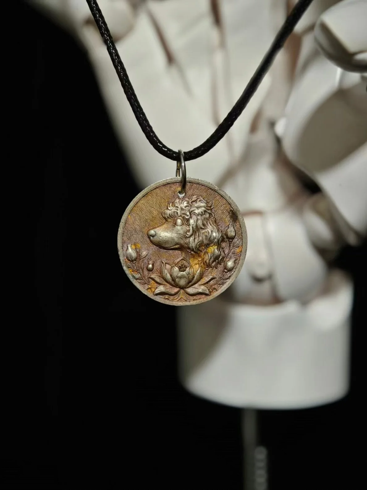 DHG Y1 You Qing You Diao Medallion - Suspended on leather cord showing front Poodle and Lotus design