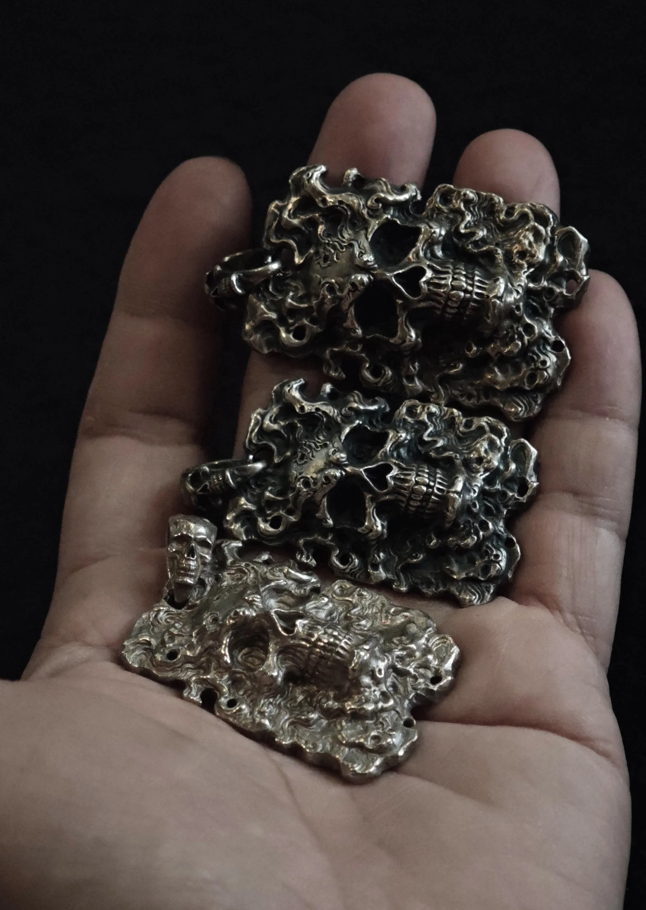 Xia Penghao FireYa Abyssal Reawakening Pendant - Large and small sizes in hand showing scale comparison