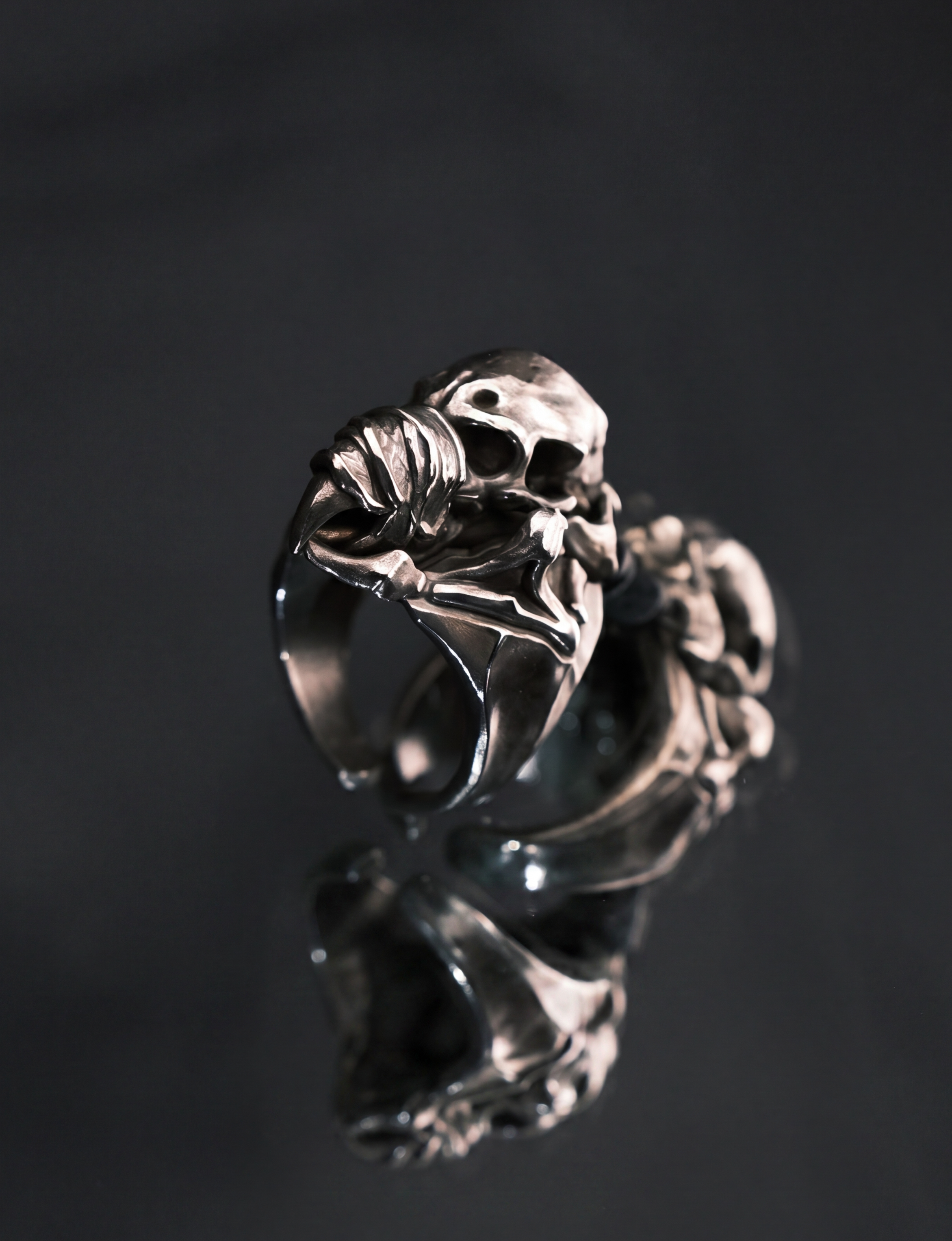 Liangshui Forge Three No Birds Muted Beak Ring - On mirrored surface, close side view showing sculptural detail