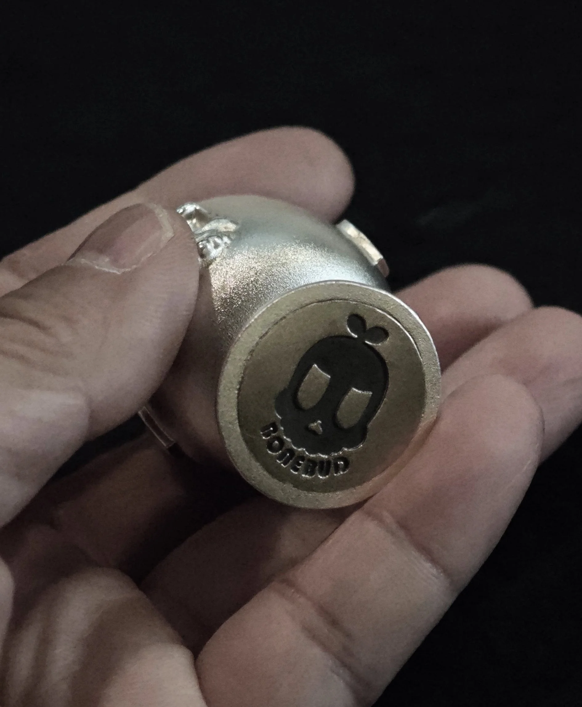 Xia Penghao BONE BUD HEART CUP - Handheld view of base showing flat BONE BUD skull logo