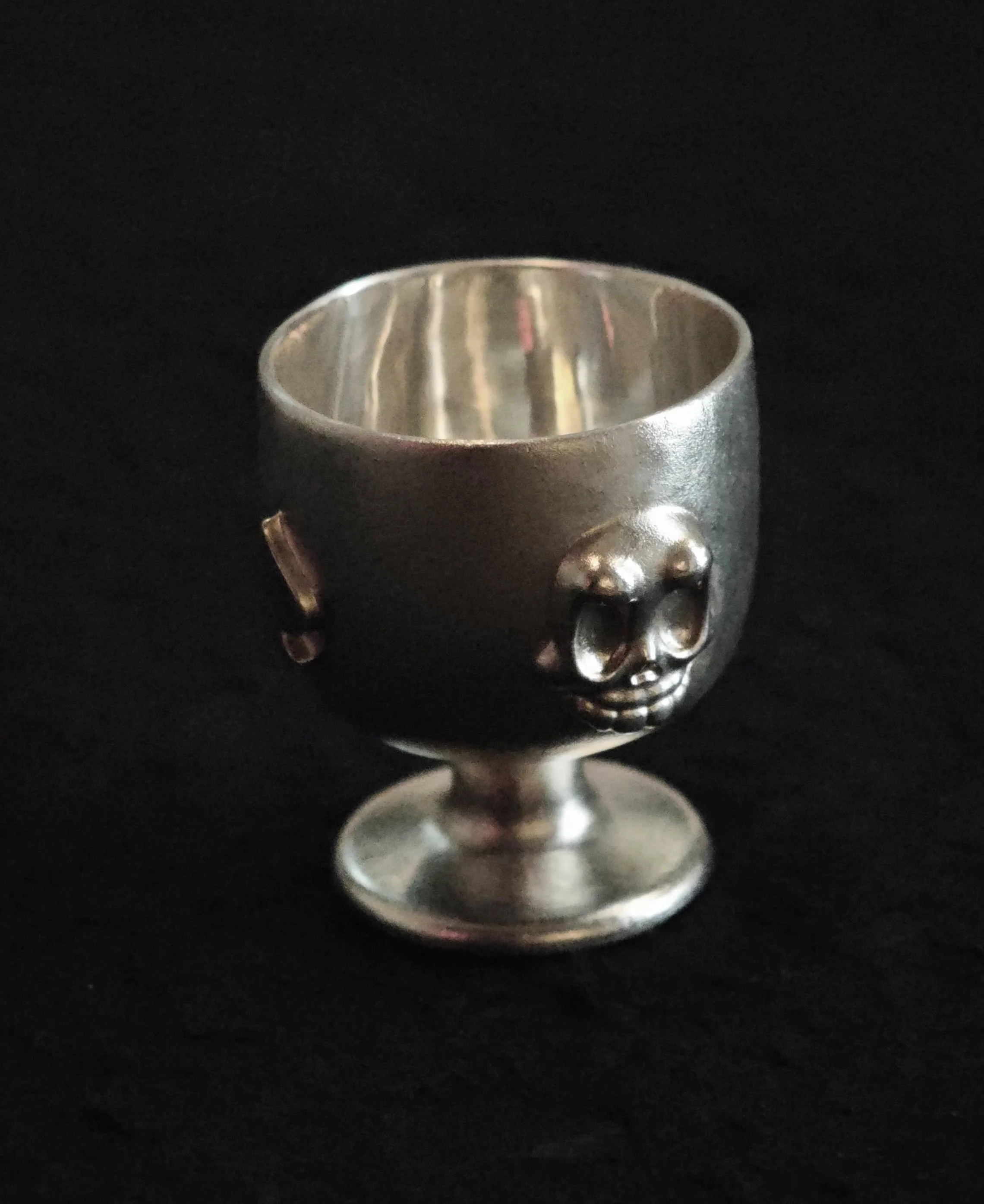 Xia Penghao BONE BUD SPADE CUP - Standing on table showing BONE BUD skull relief
