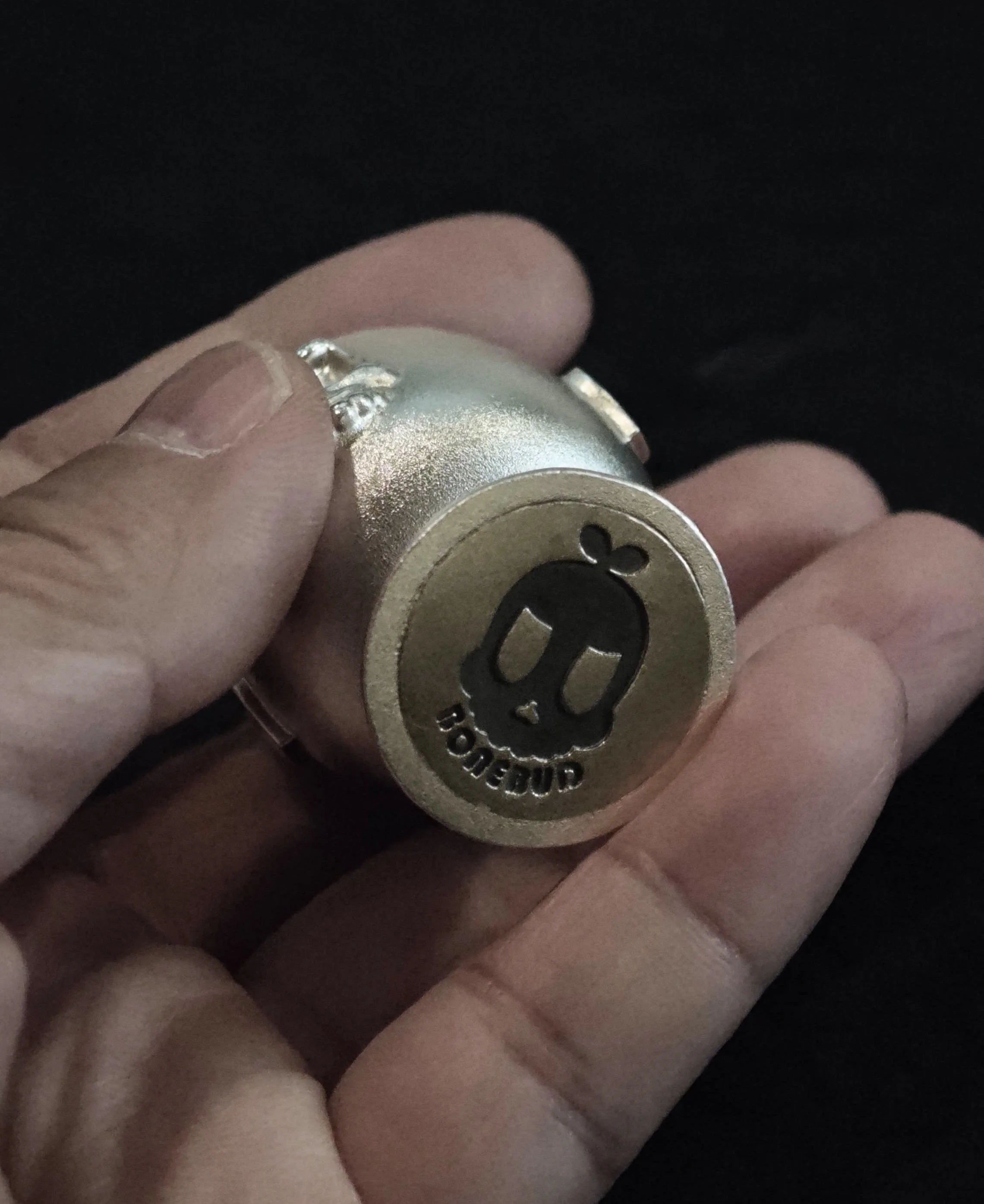 Xia Penghao BONE BUD SPADE CUP - Handheld view of base showing flat BONE BUD skull logo