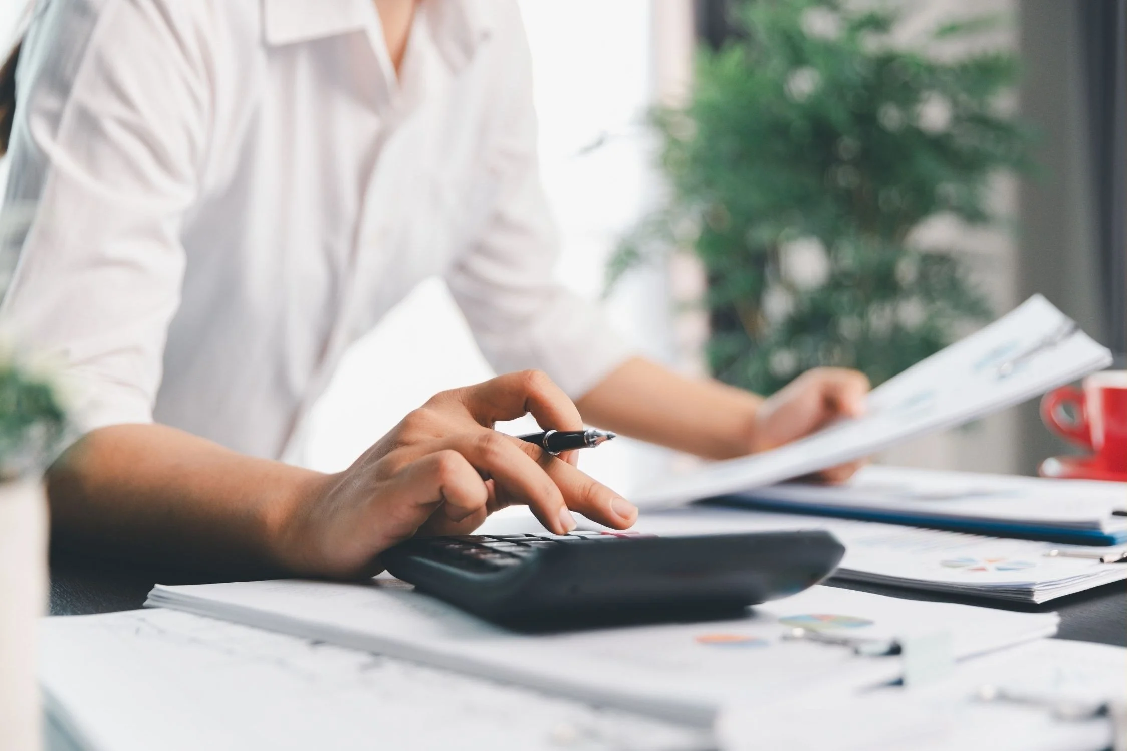 Tax professional using a calculating machine.