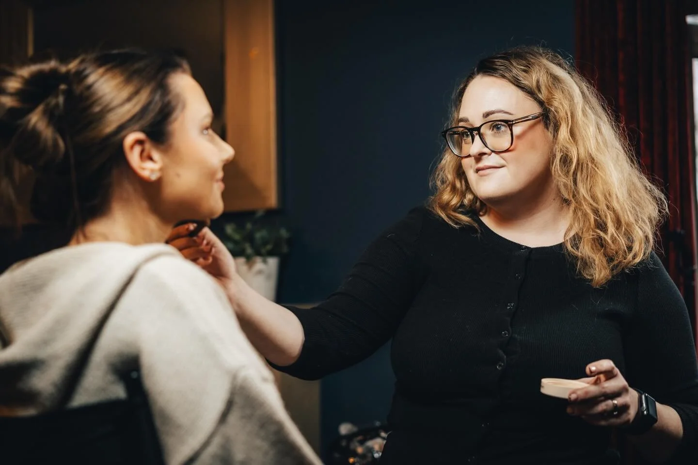 makeup artist applying bridal makeup