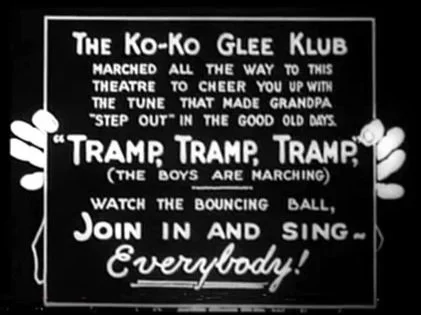   Koko holds up cards to start off the singing to Tramp! Tramp! Tramp!  