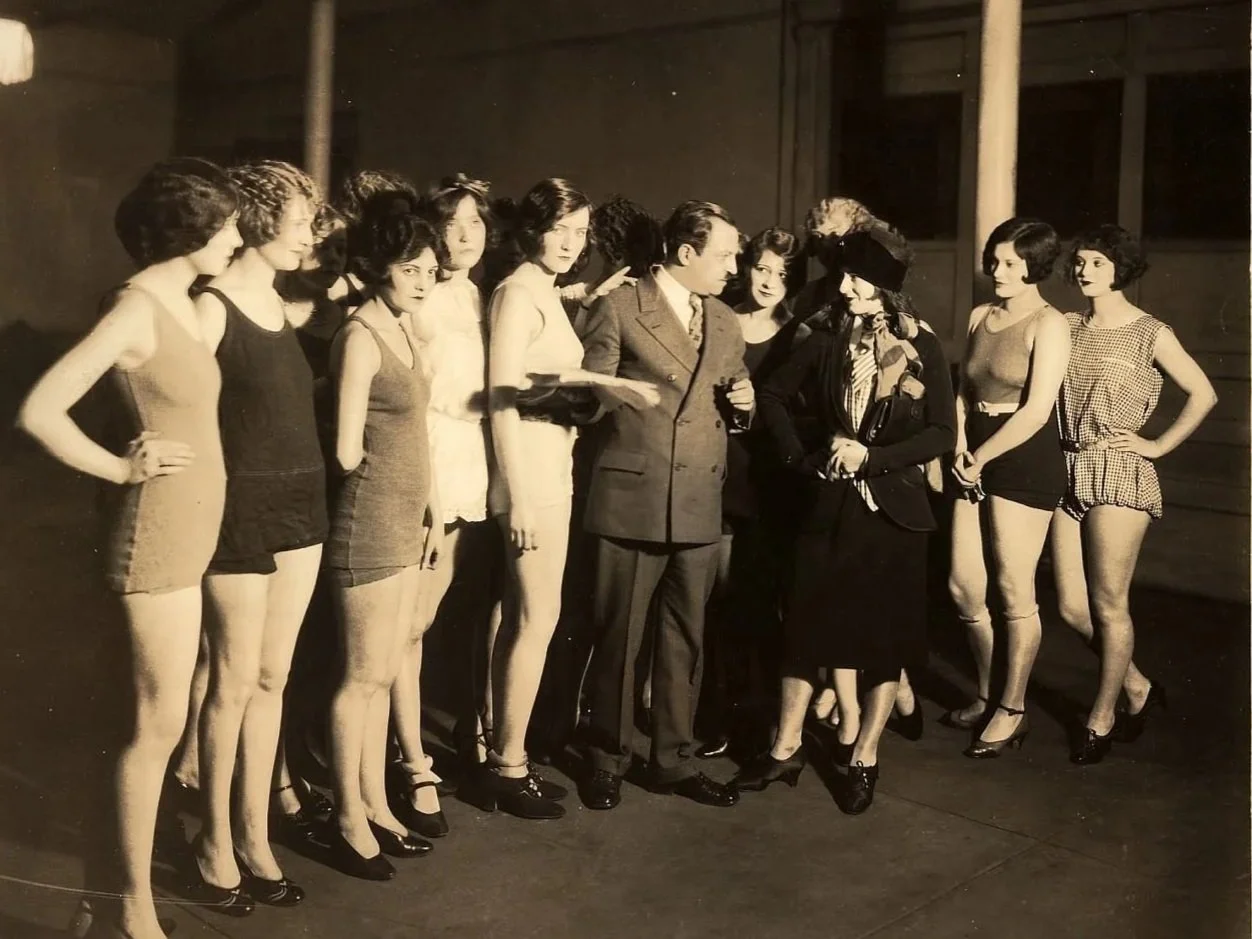  Max Fleischer (center) talking to his daughter Ruth (wearing hat). A note on the reverse of this photo reads "Max Fleischer and a group of the prettiest chorus girls in New York, all of whom are engaged for his new series of two reel comedies, Carri