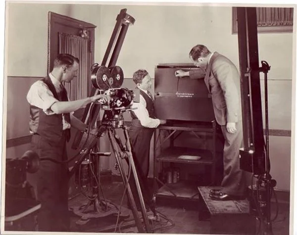 Left to Right: Charles Schettler (camera department), Lou Fleischer (head of the music department), and Max Fleischer (on box), preparing a Bouncing Ball film. Undated, possibly early 1930′s. The Fleischer Family Collection
